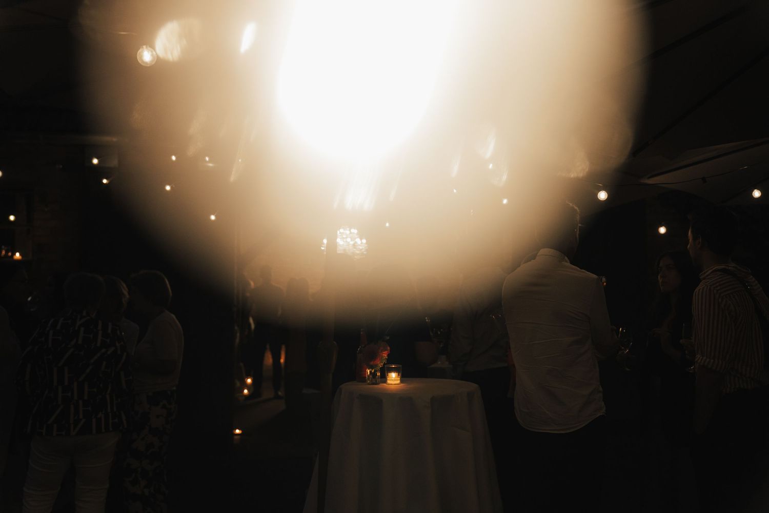 Soft focus lighting effects create a dreamy atmosphere at an evening outdoor event.