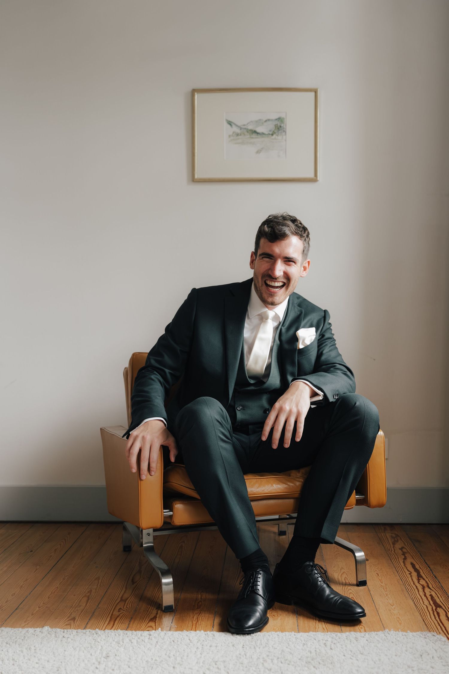 Multiple angles of someone seated on a vintage leather chair in formal wear.