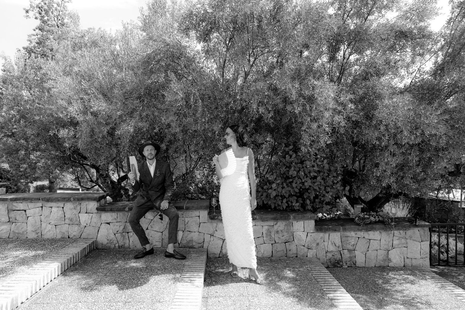Wedding photo sequence showing a couple walking through an olive grove garden.