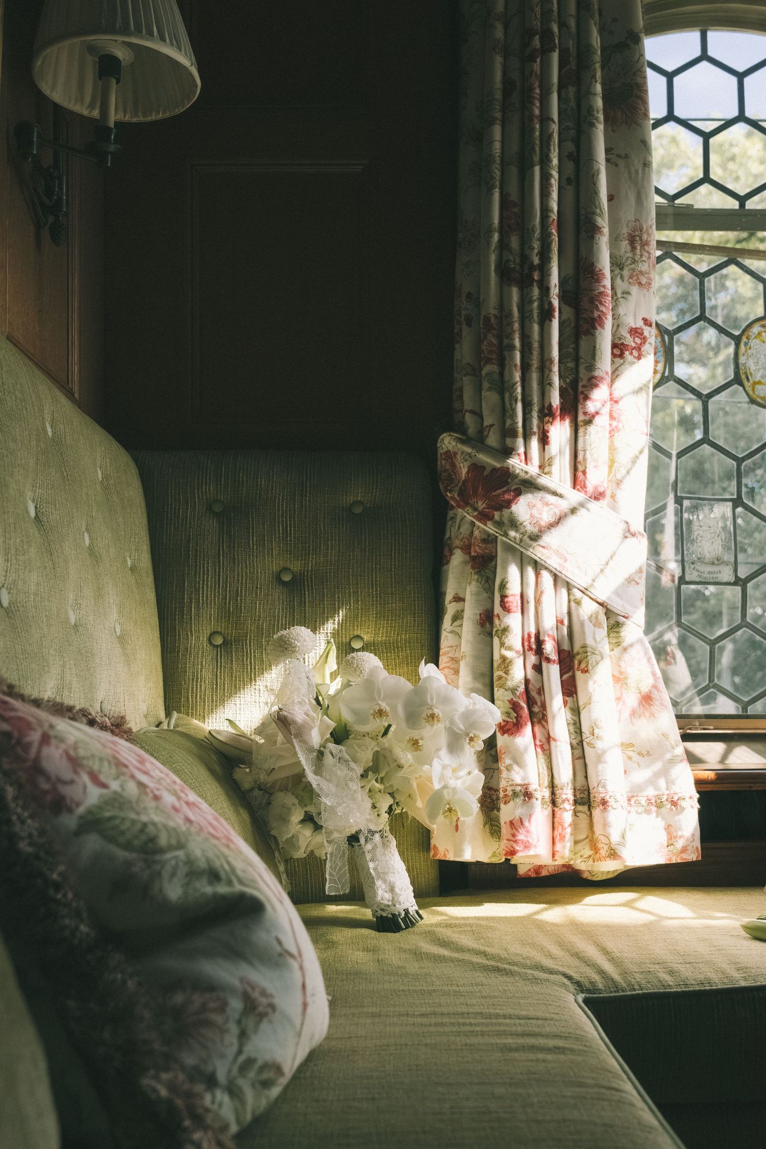 Vintage window with lace curtains and soft natural lighting in an old room.