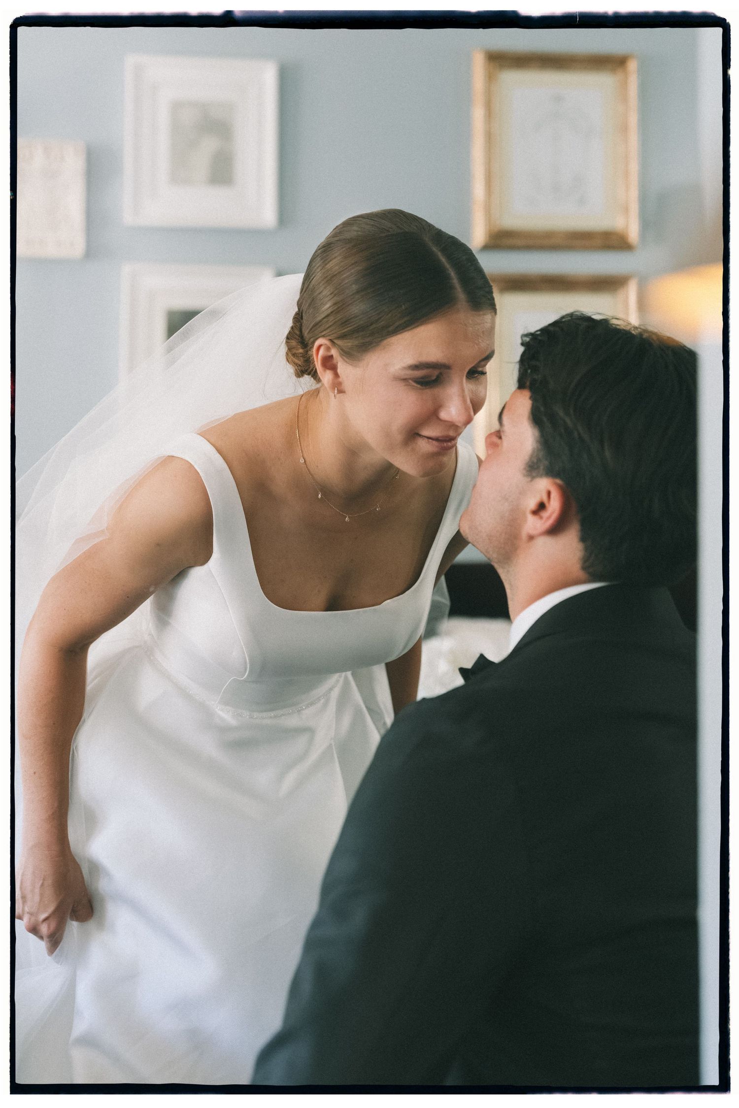 A tender moment captured between a couple in formal wedding attire.