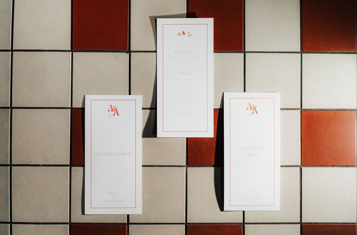 Modern interior wall design with geometric patterns in white and terracotta colors.