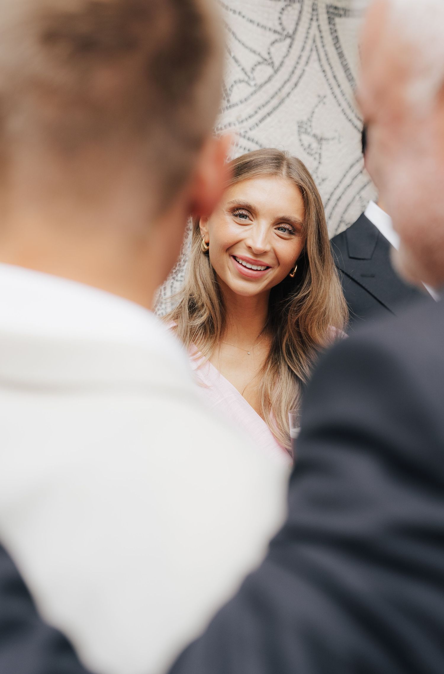 Close-up candid shot of wedding guests during a celebration.