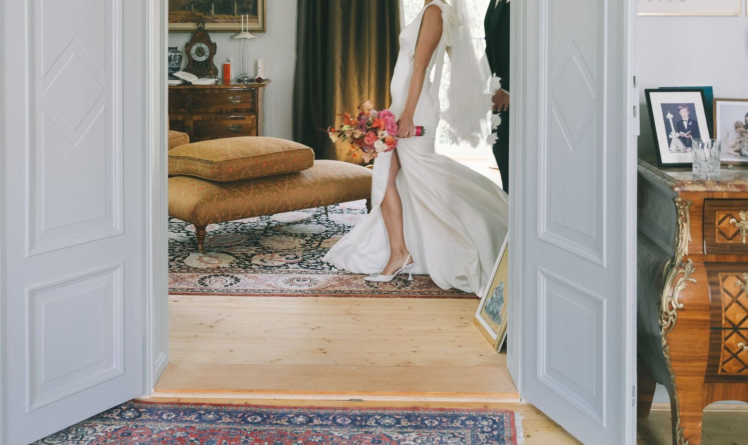 Wedding dress movement captured through multiple doorways in an elegant home.