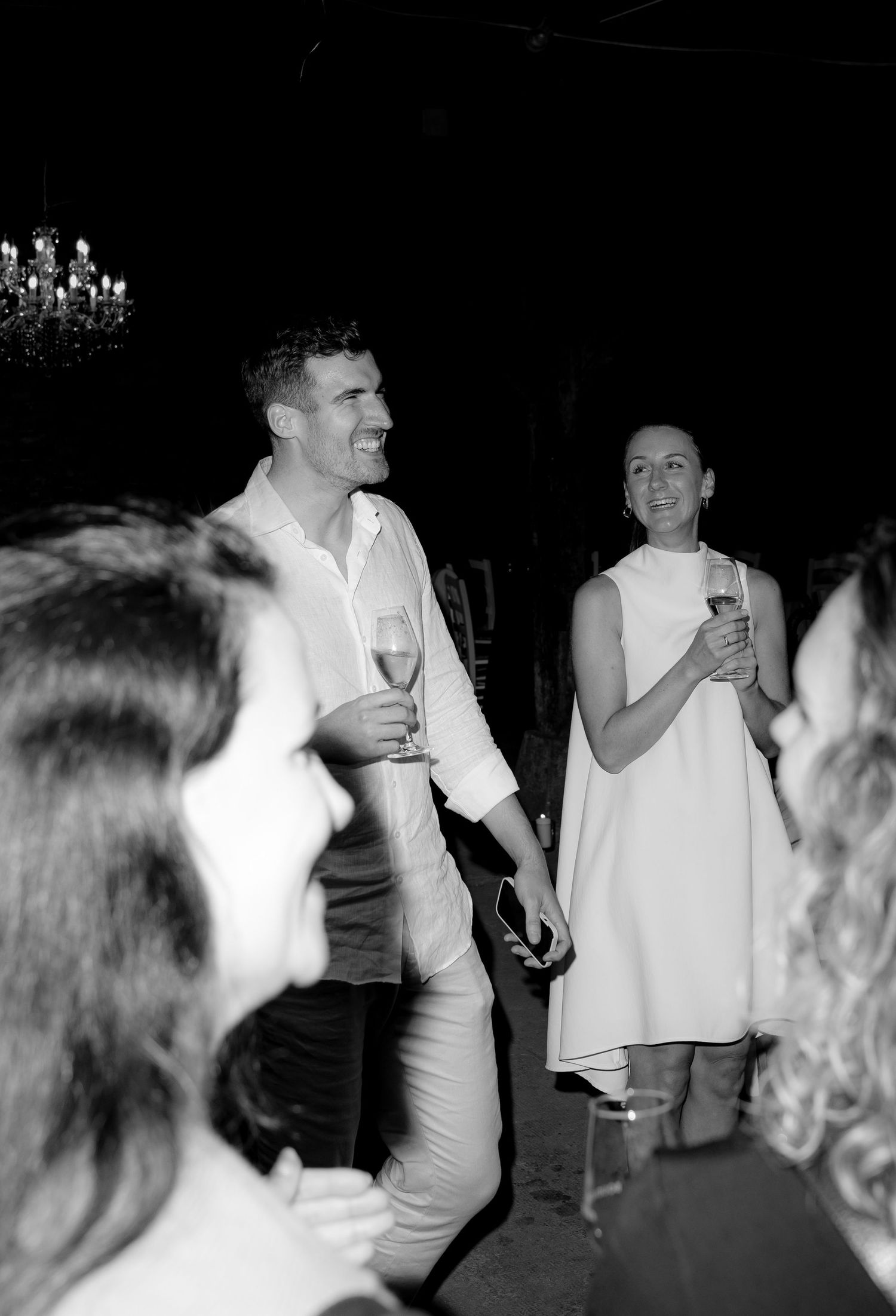 Black and white images of guests dancing and celebrating at a nighttime wedding reception.