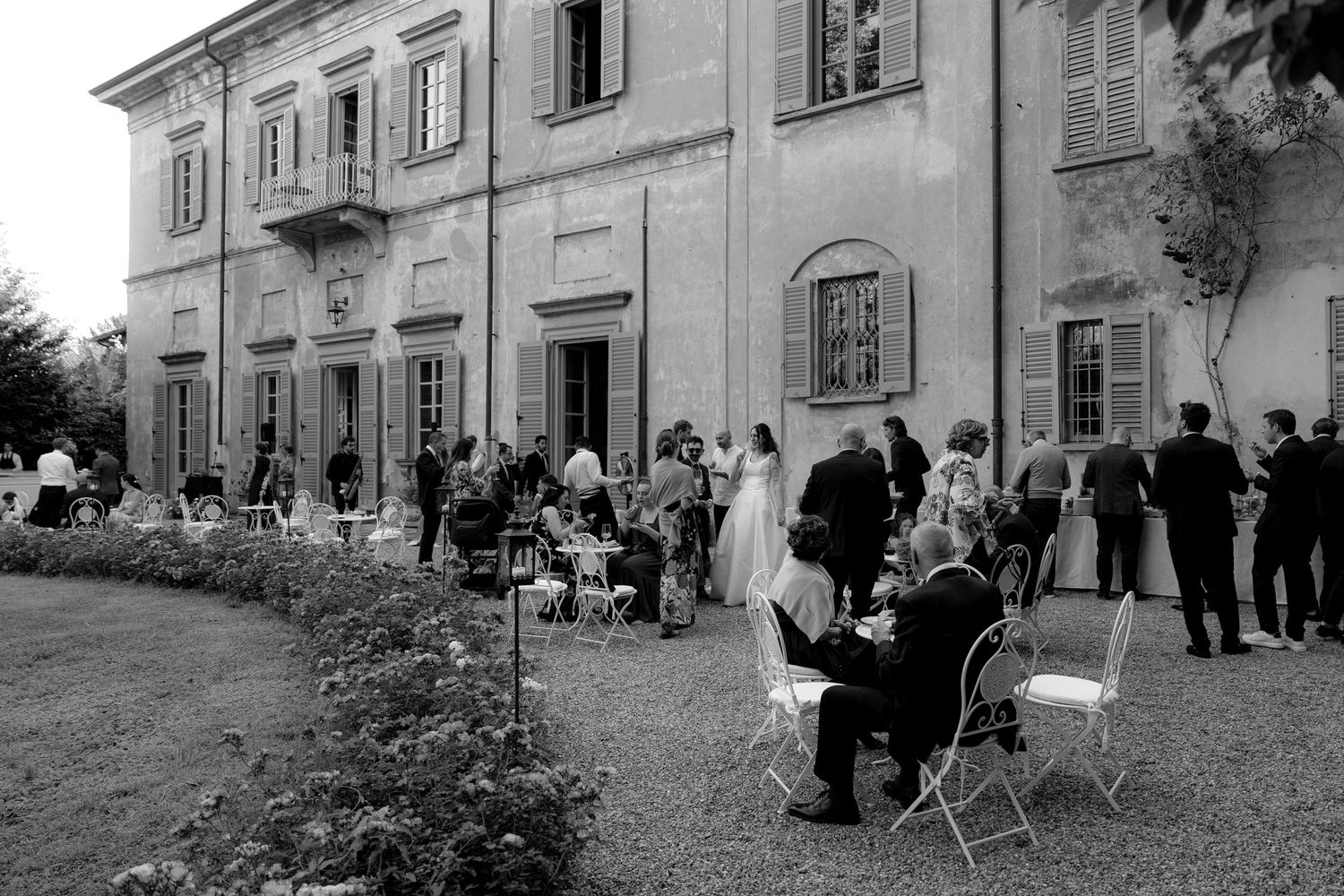 Black and white photos of people gathering outside a classic European-style building.