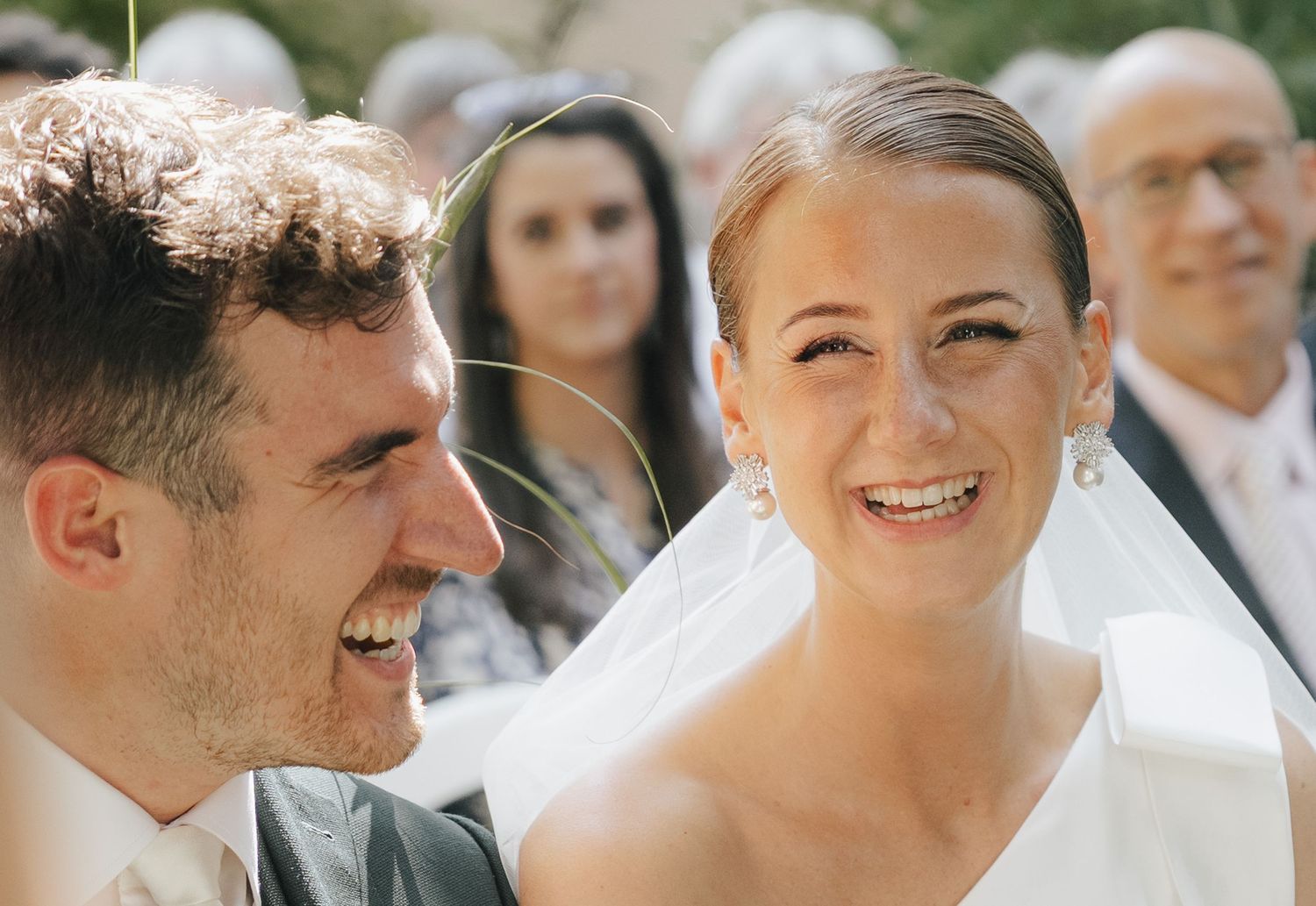 A joyful moment captured during an outdoor wedding celebration.