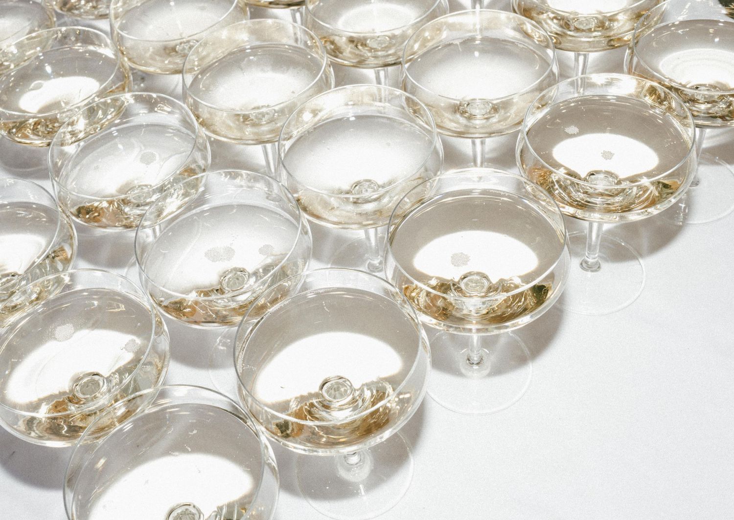 Close-up arrangement of crystal glass coasters with gold trim details.