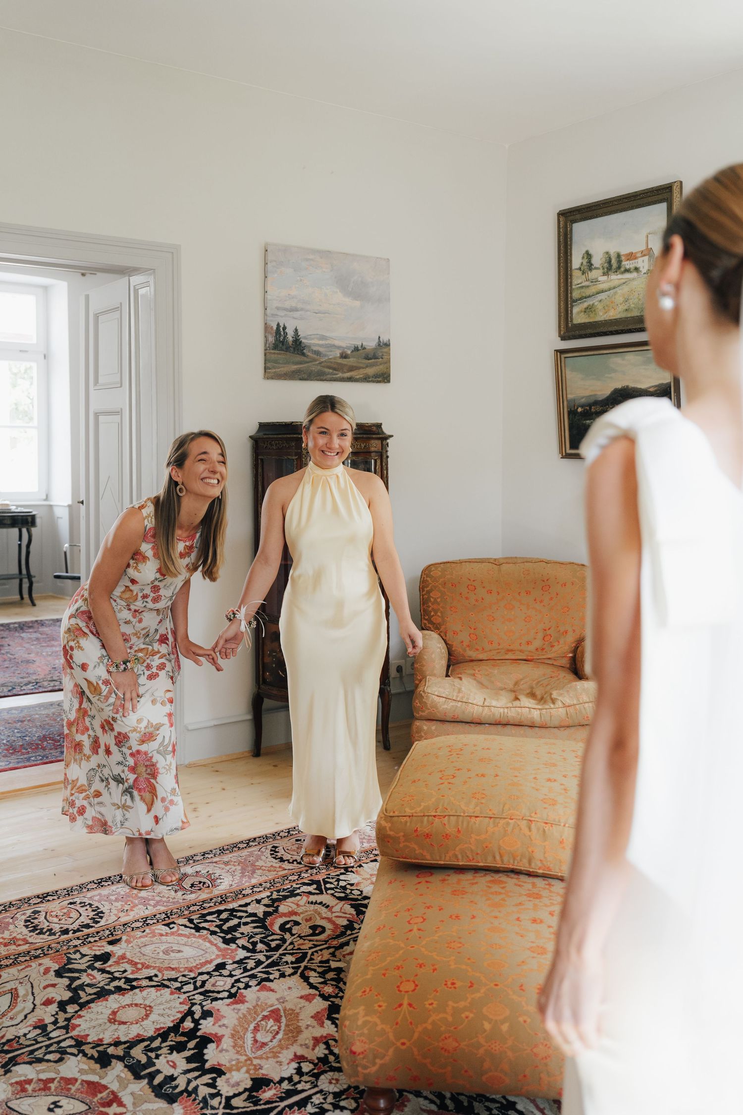 Joyful wedding preparation moment in bright room with vintage furniture and decor.