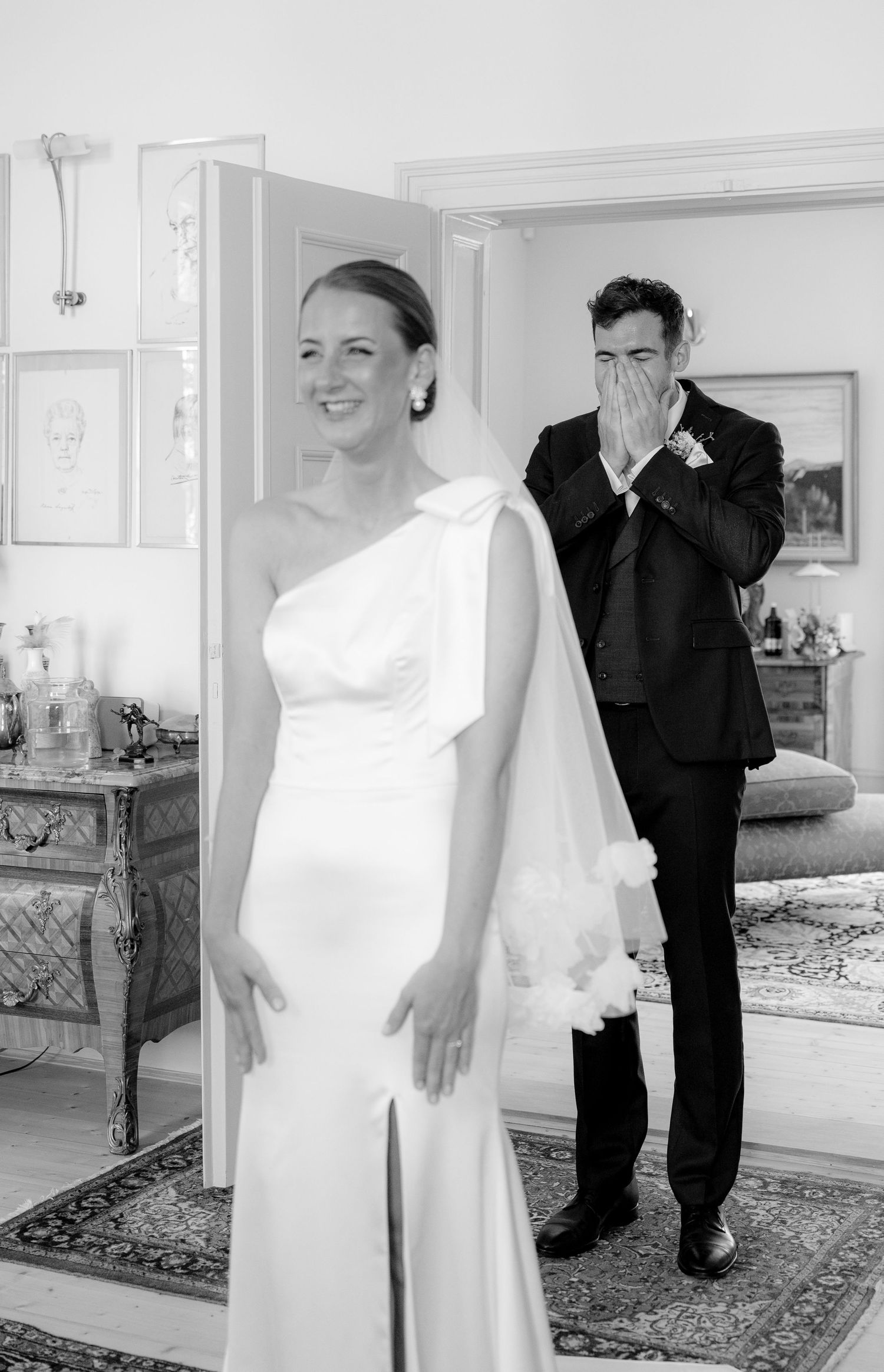 Wedding preparation scene in an elegant room with mirrors and formal attire.