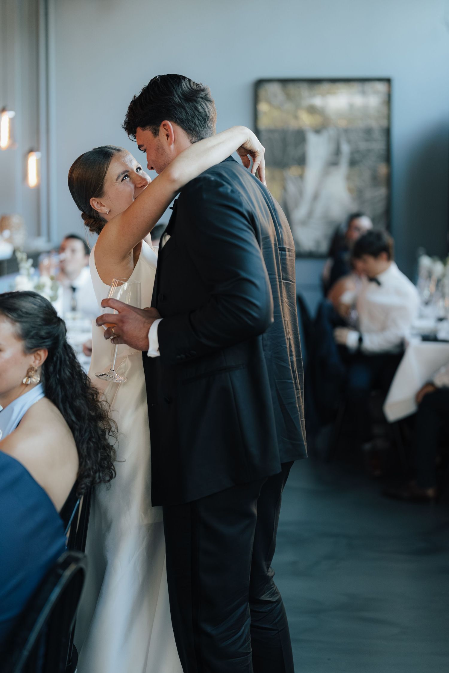A romantic moment shared between a couple during their wedding reception.