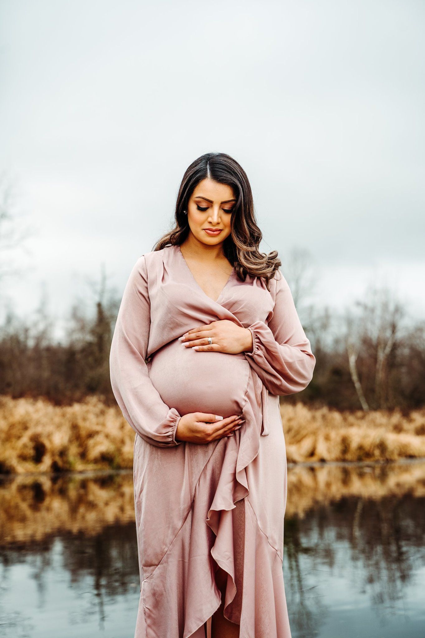 A pregnant mother at burnaby lake during her maternity shoot, a naturally during a maternity photography session in Burnaby, BC.