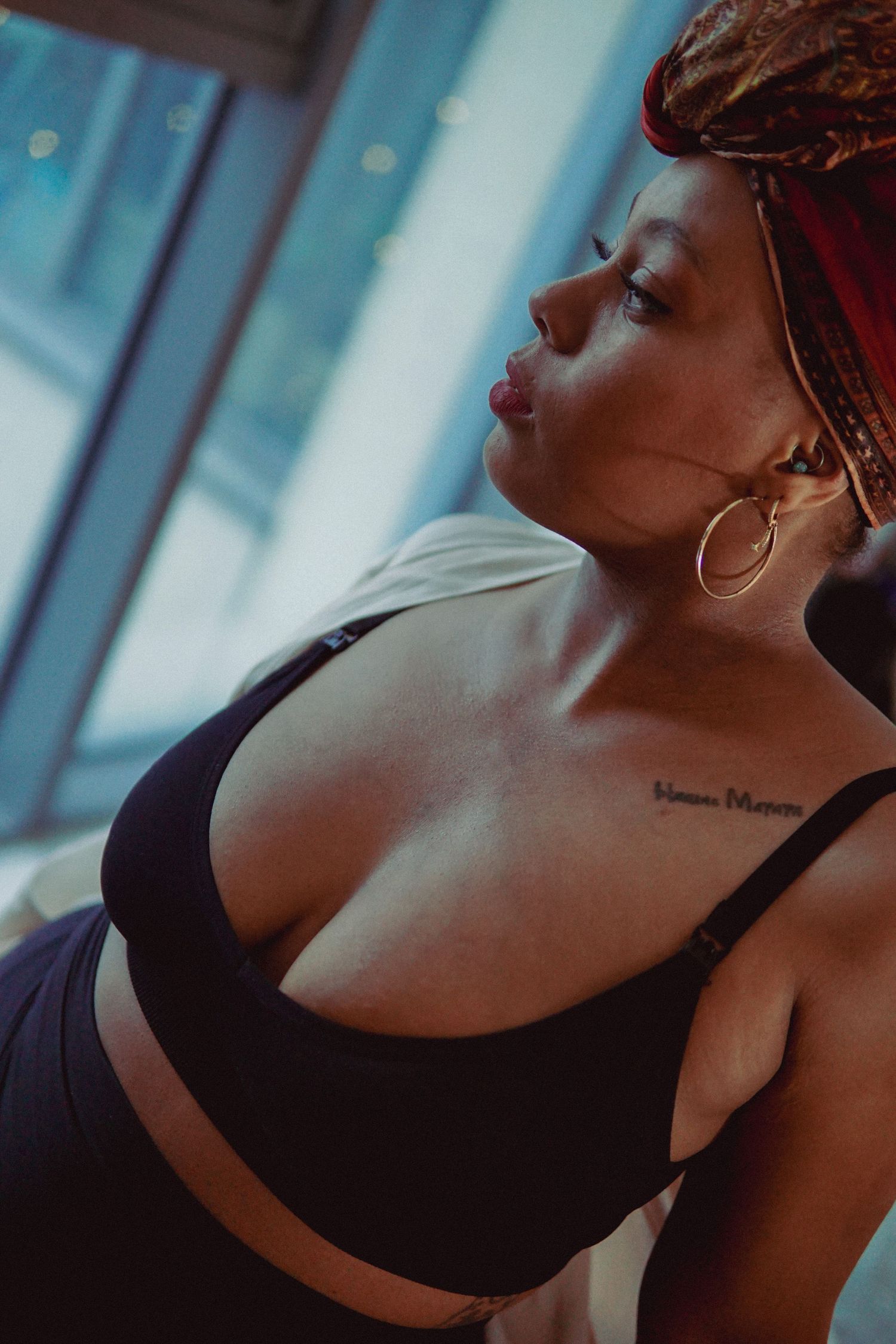 Portrait of woman in red headscarf and black bra looking away Boudoir photography UK Liverpool
