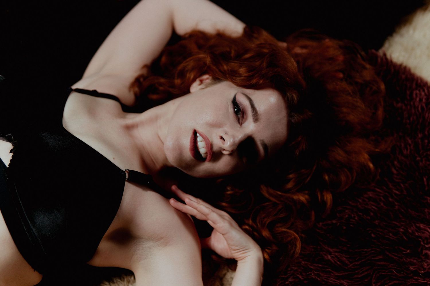Ginger woman laying on a floor looking into camera Boudoir photography UK Liverpool