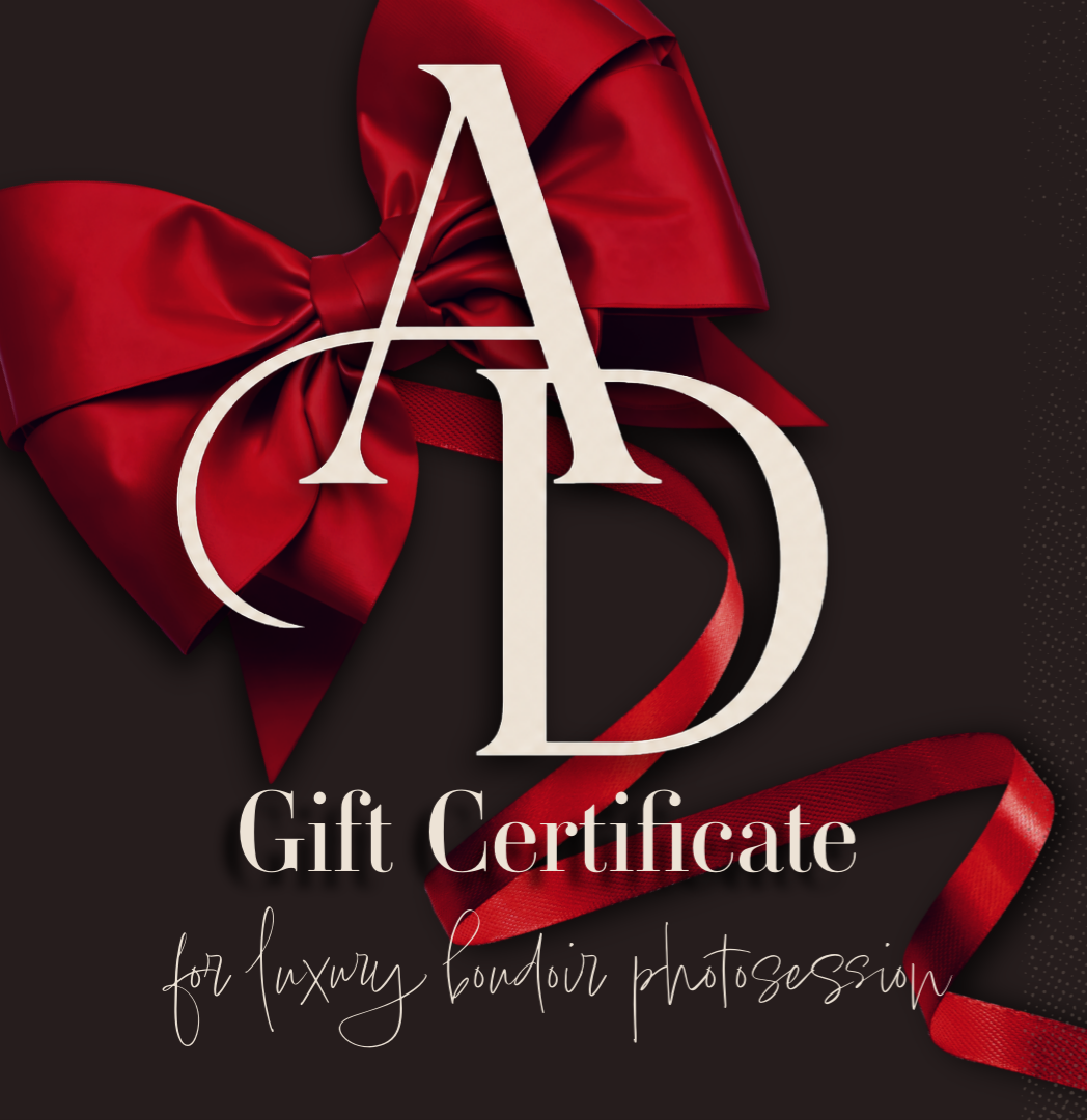 Elegant gift certificate for a luxury boudoir photosession featuring red satin bow and AD monogram on dark background.