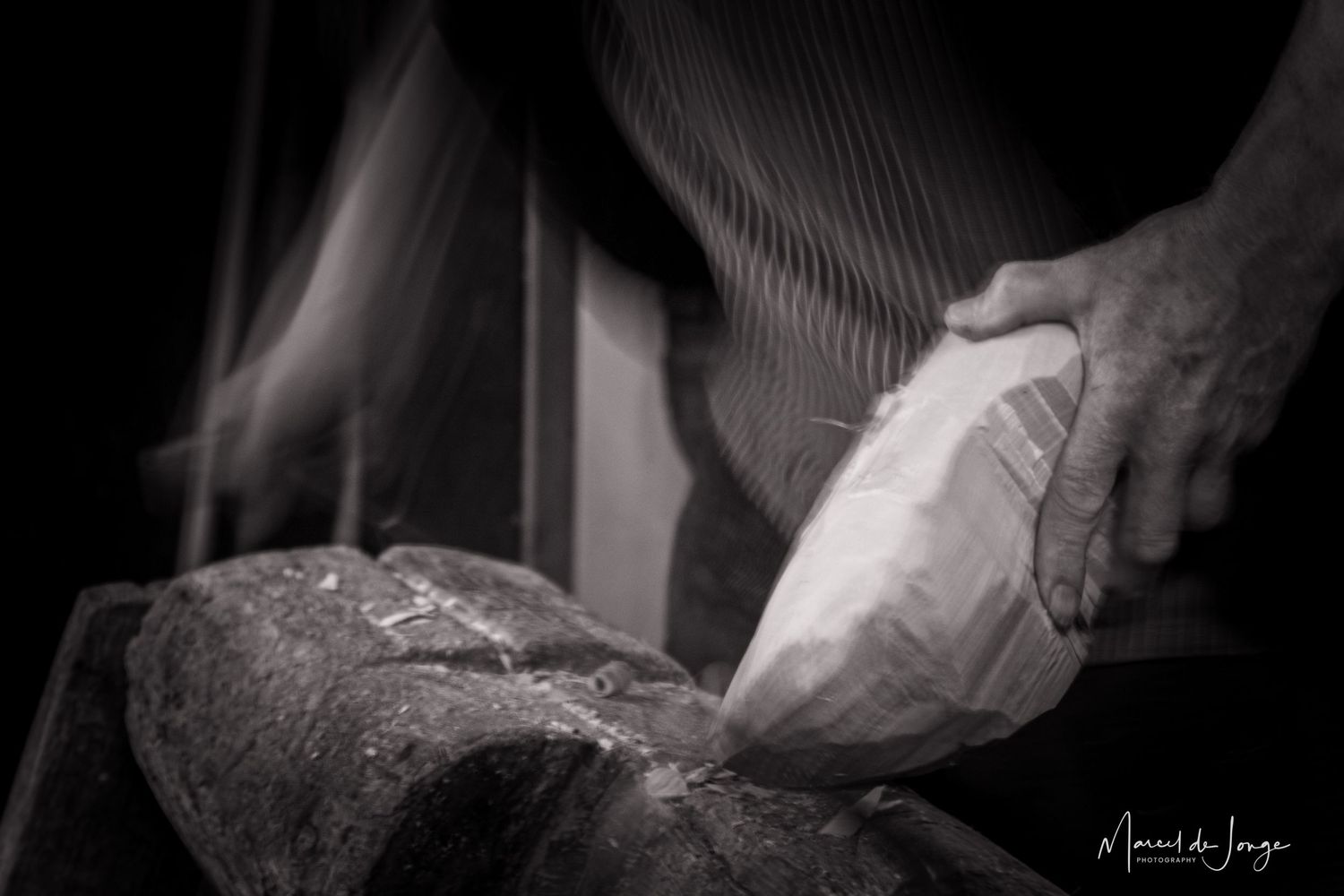 Black and white close-up shots of hands kneading and shaping bread dough on a floured surface.