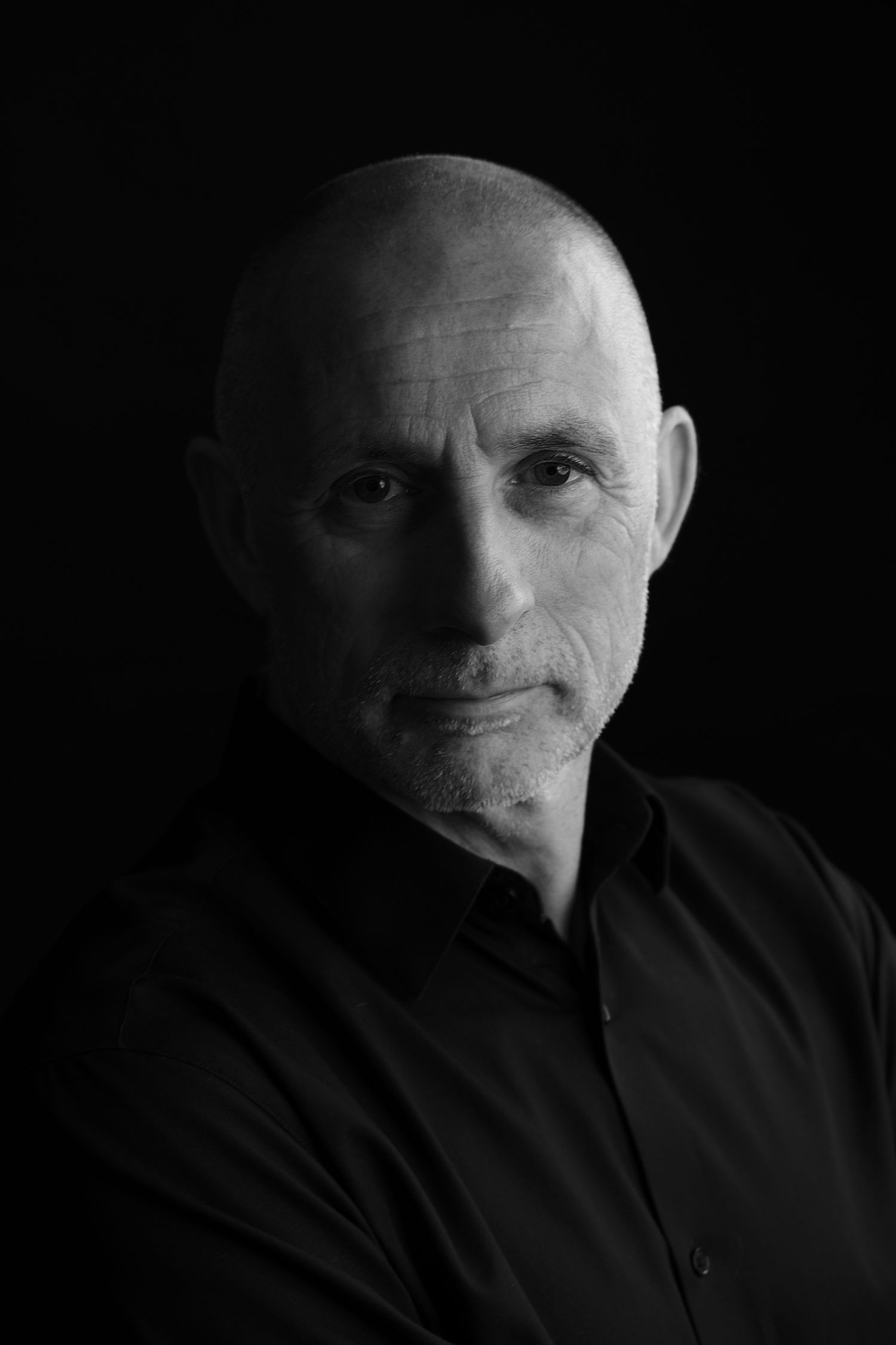 A series of black and white portraits showing different angles of a person's face against a dark background.