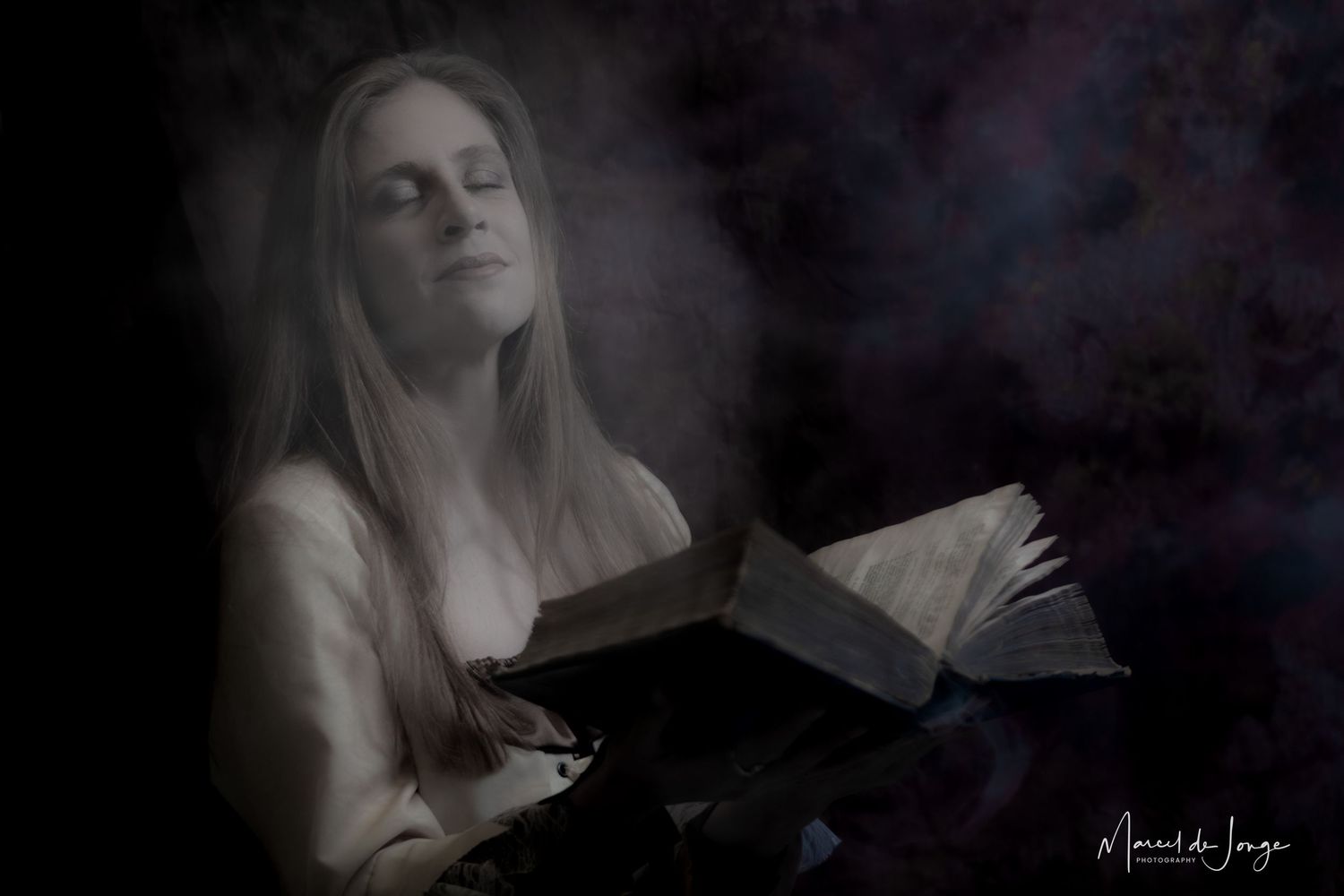 A dramatic black and white portrait series showing a person with flowing hair against a dark background.