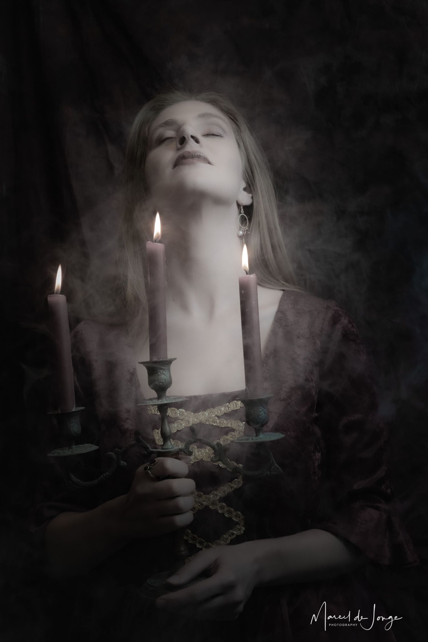 Moody black and white photo series of lit candles and shadows creating an ethereal gothic atmosphere.