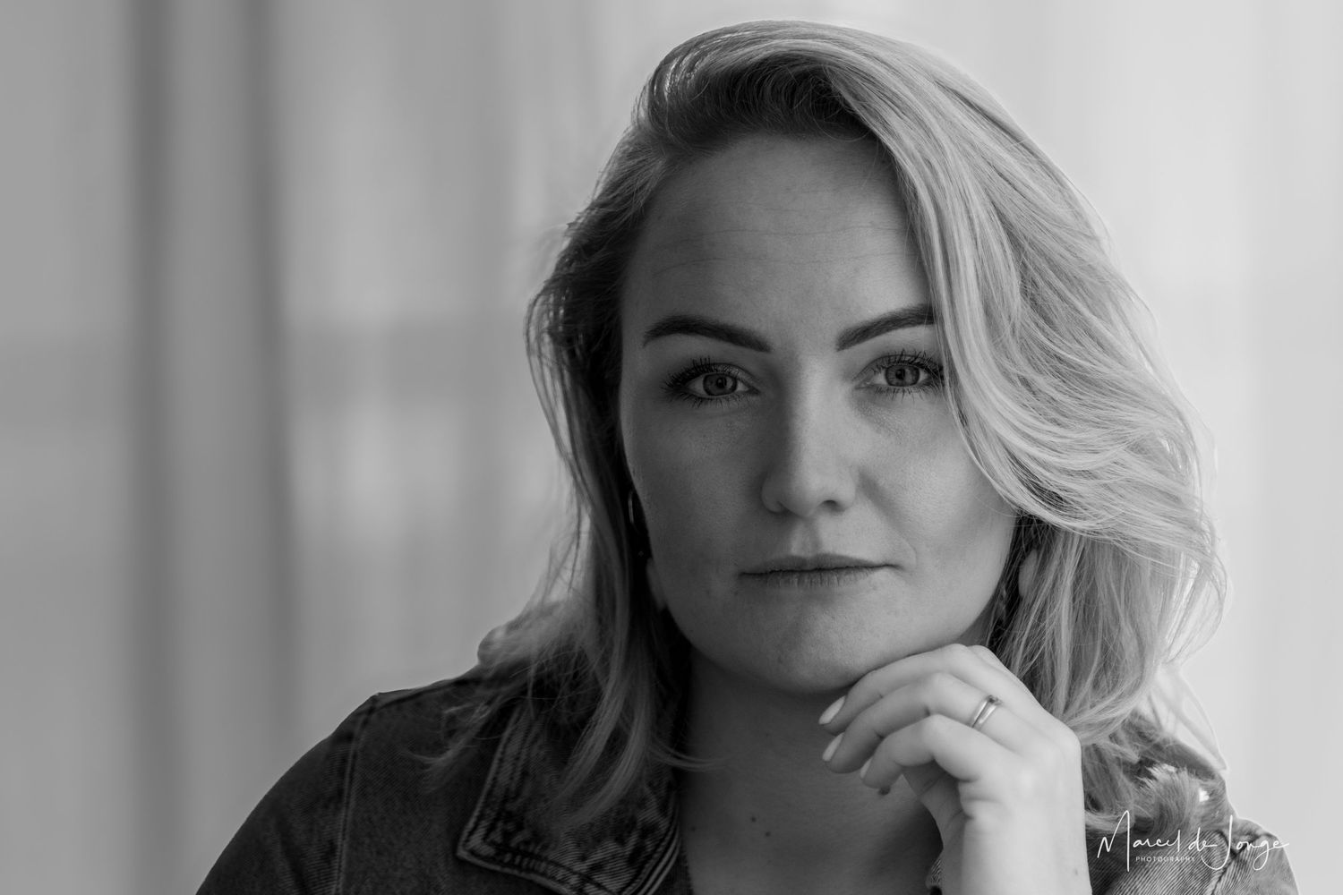 A series of black and white portrait photos showing different angles and expressions of a woman with blonde hair.