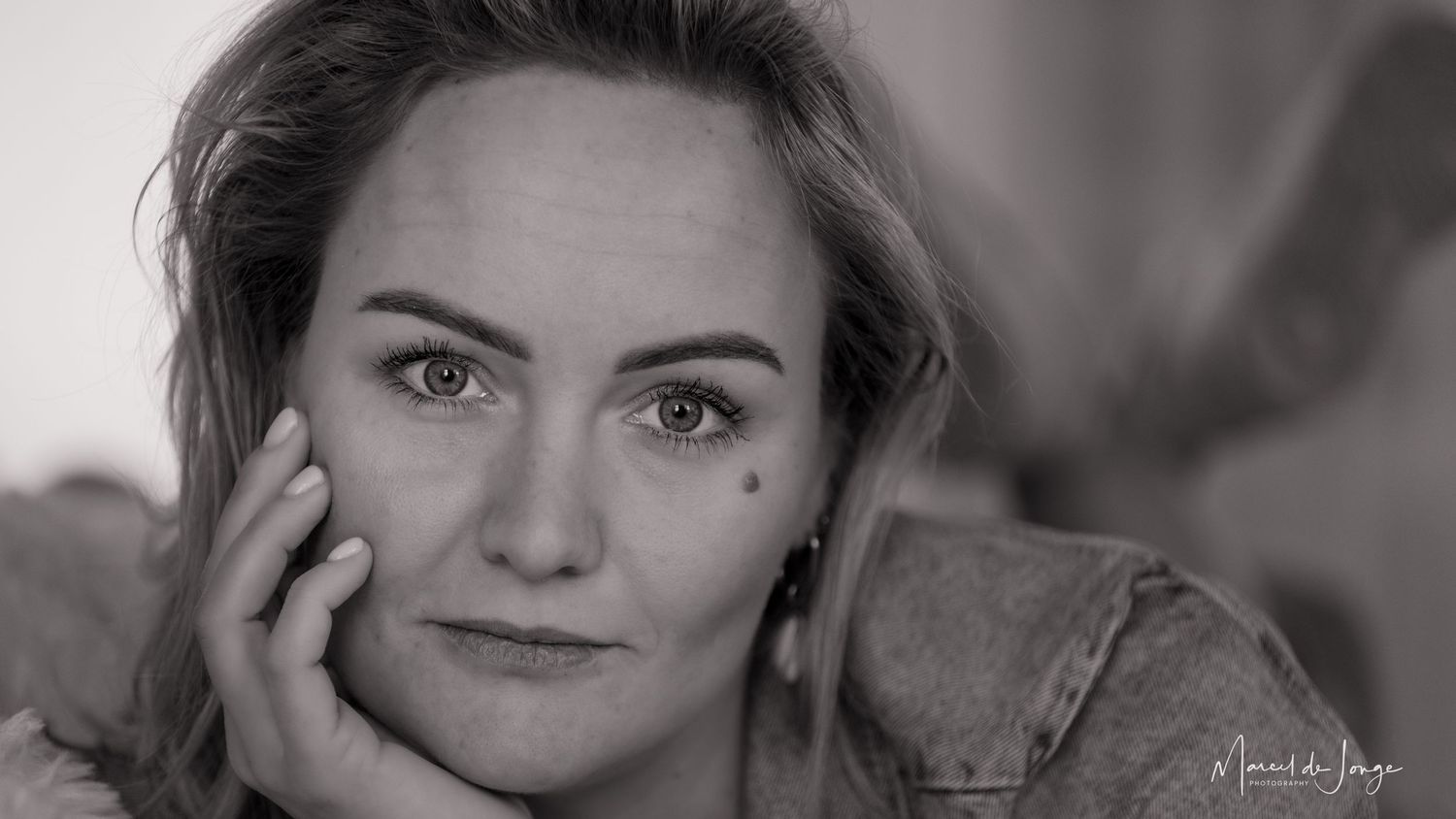 A black and white collage of artistic portrait photographs showing different angles and expressions.