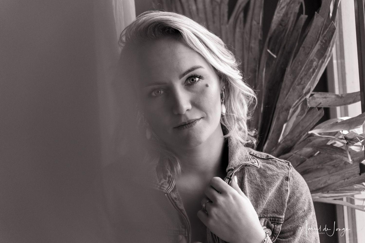 Black and white portrait collage showing six different artistic headshots with dramatic lighting and expressions.