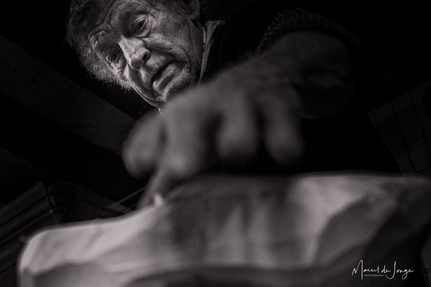 A dramatic black and white portrait series showing different emotional expressions and poses in moody lighting.