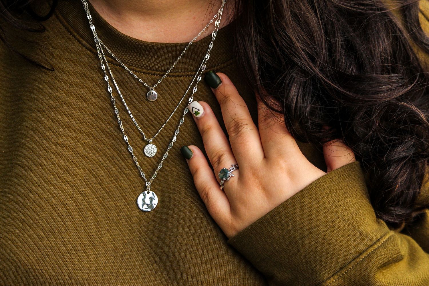 Detail shot of woman's necklace and ring, Near Calgary, AB