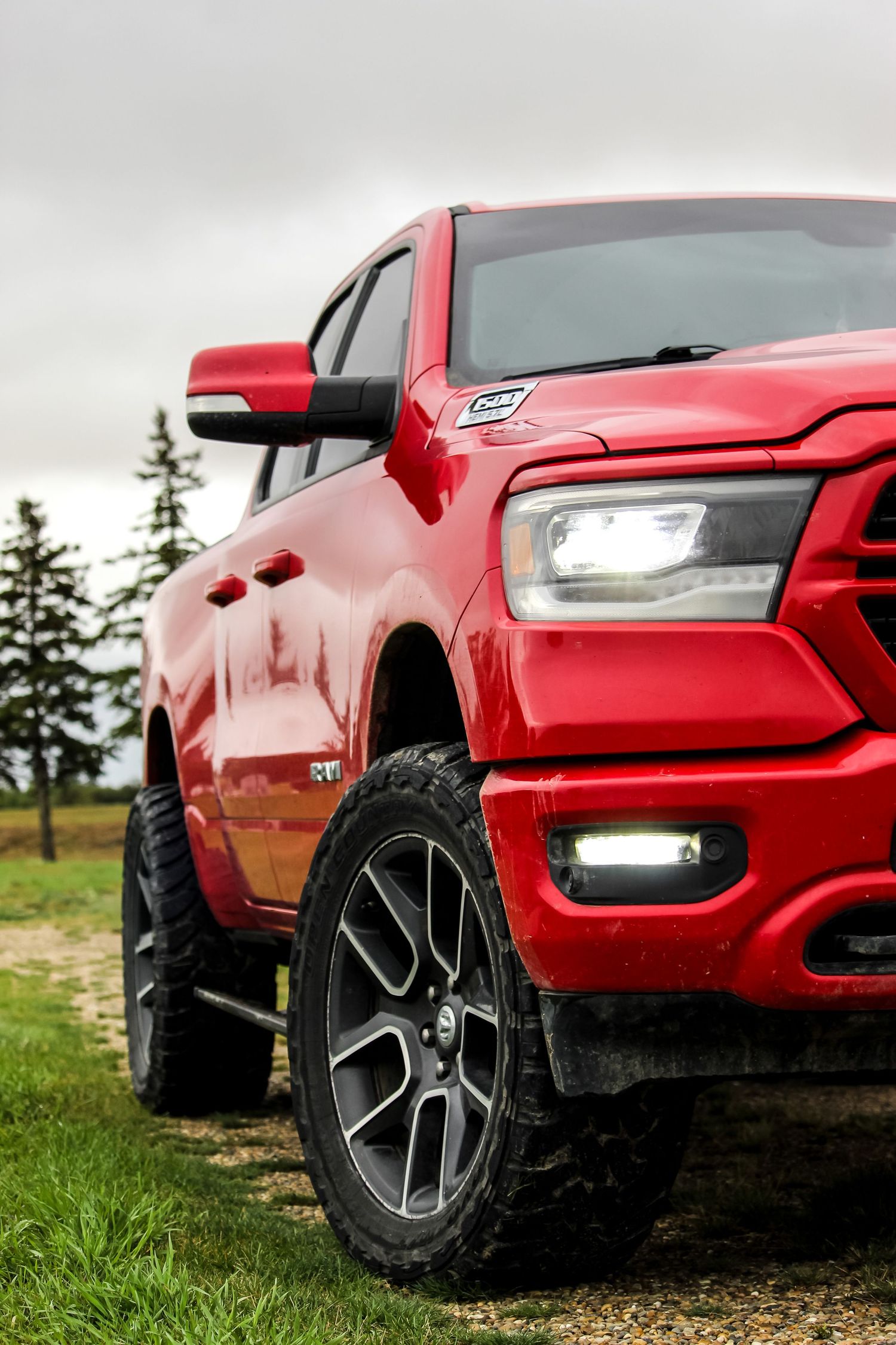 Red dodge truck from front corner with moody background in Fairview, AB