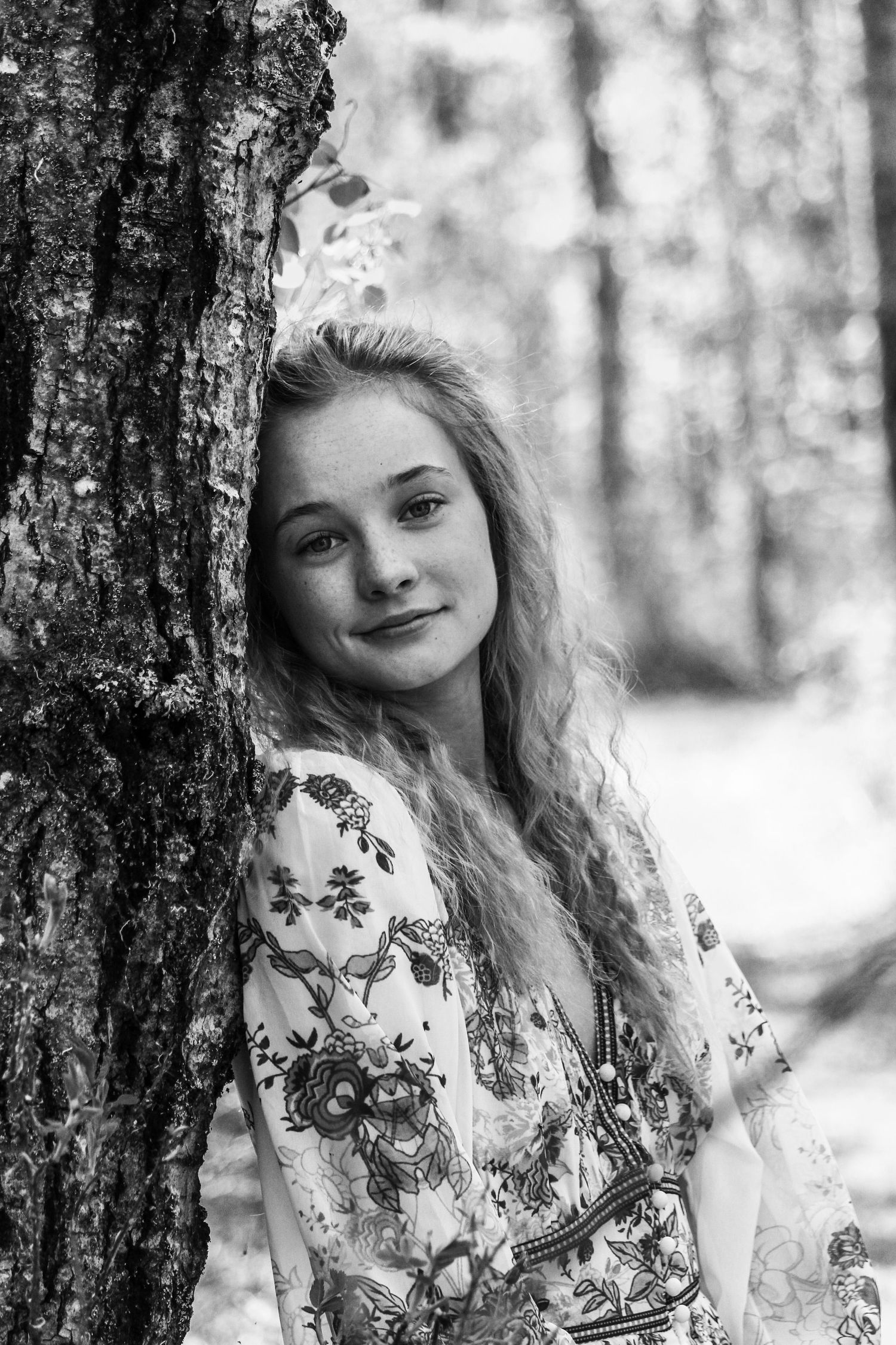 girl leaning against tree, close-up at Lac Cardinal, AB