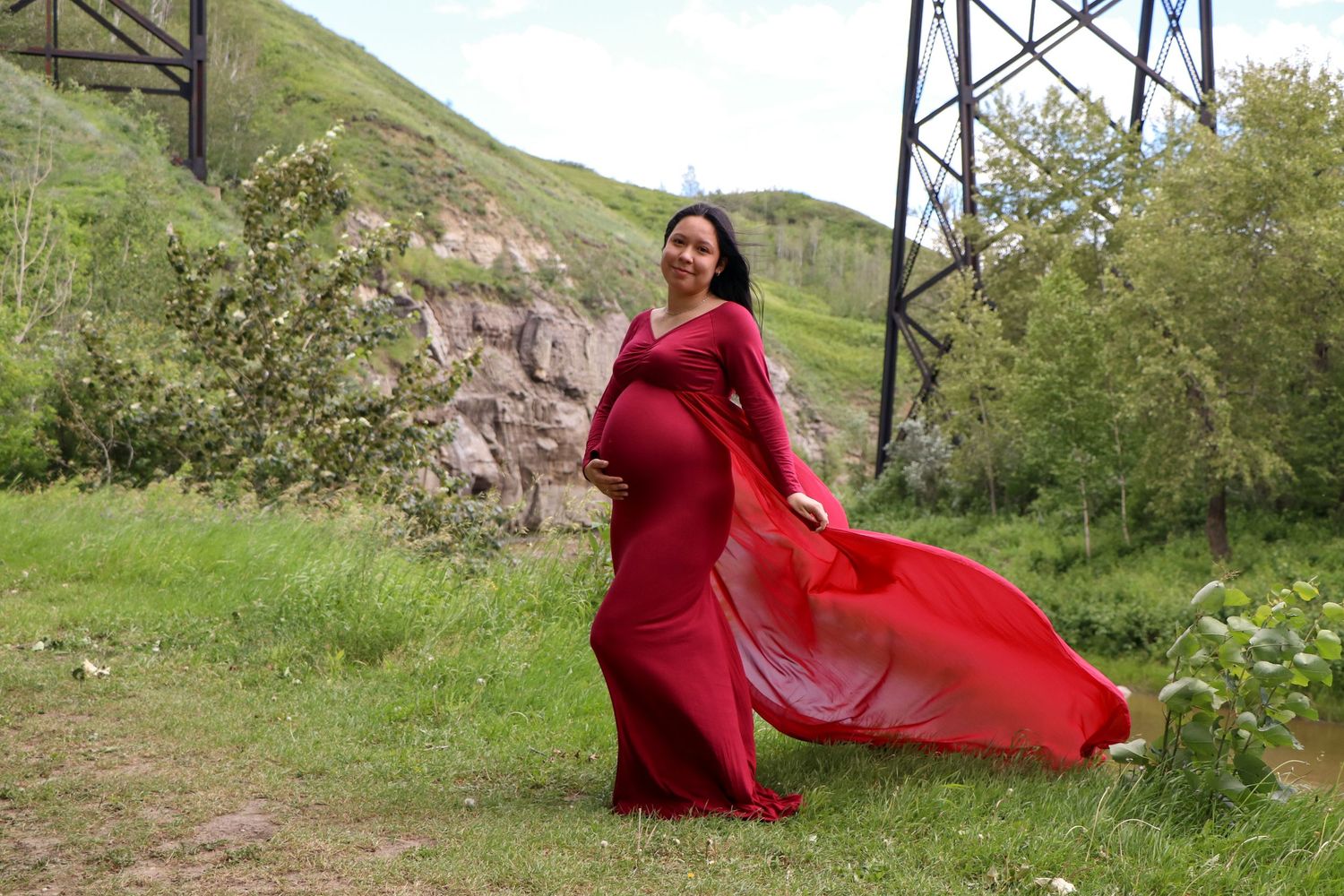 Pregnant woman in red dress in Peace River, AB