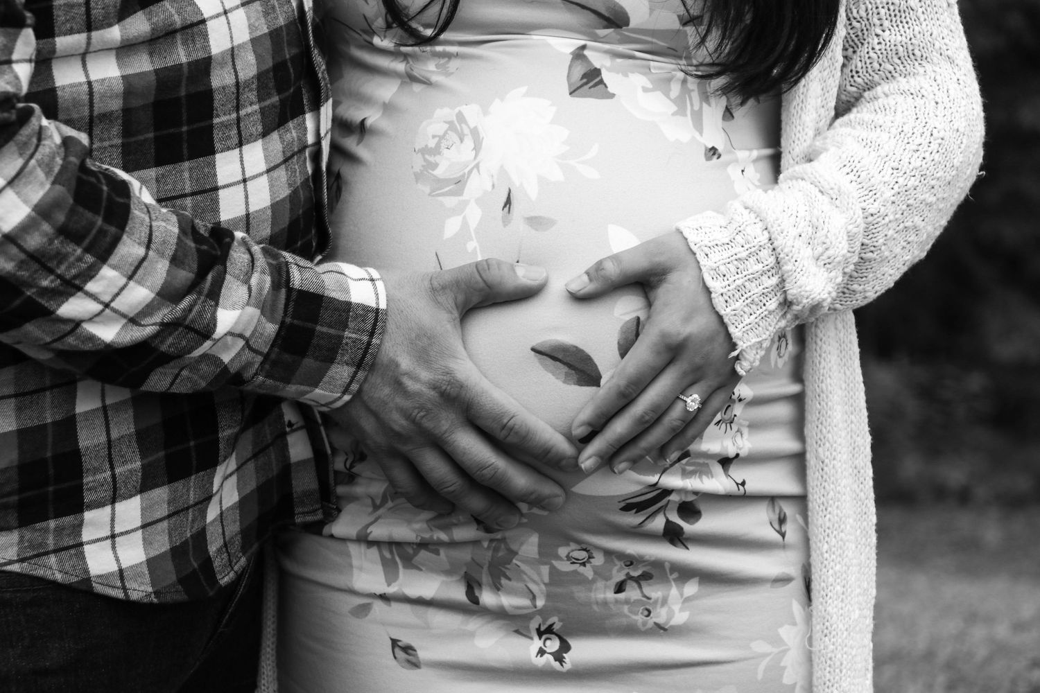 pregnancy close-up shot at Wilderness Park, man and woman hands making heart on belly