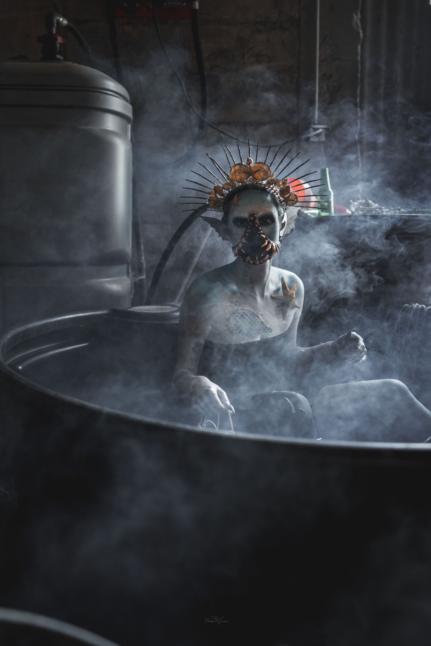 Artistic still life with smoke effects and metallic objects in dark setting.