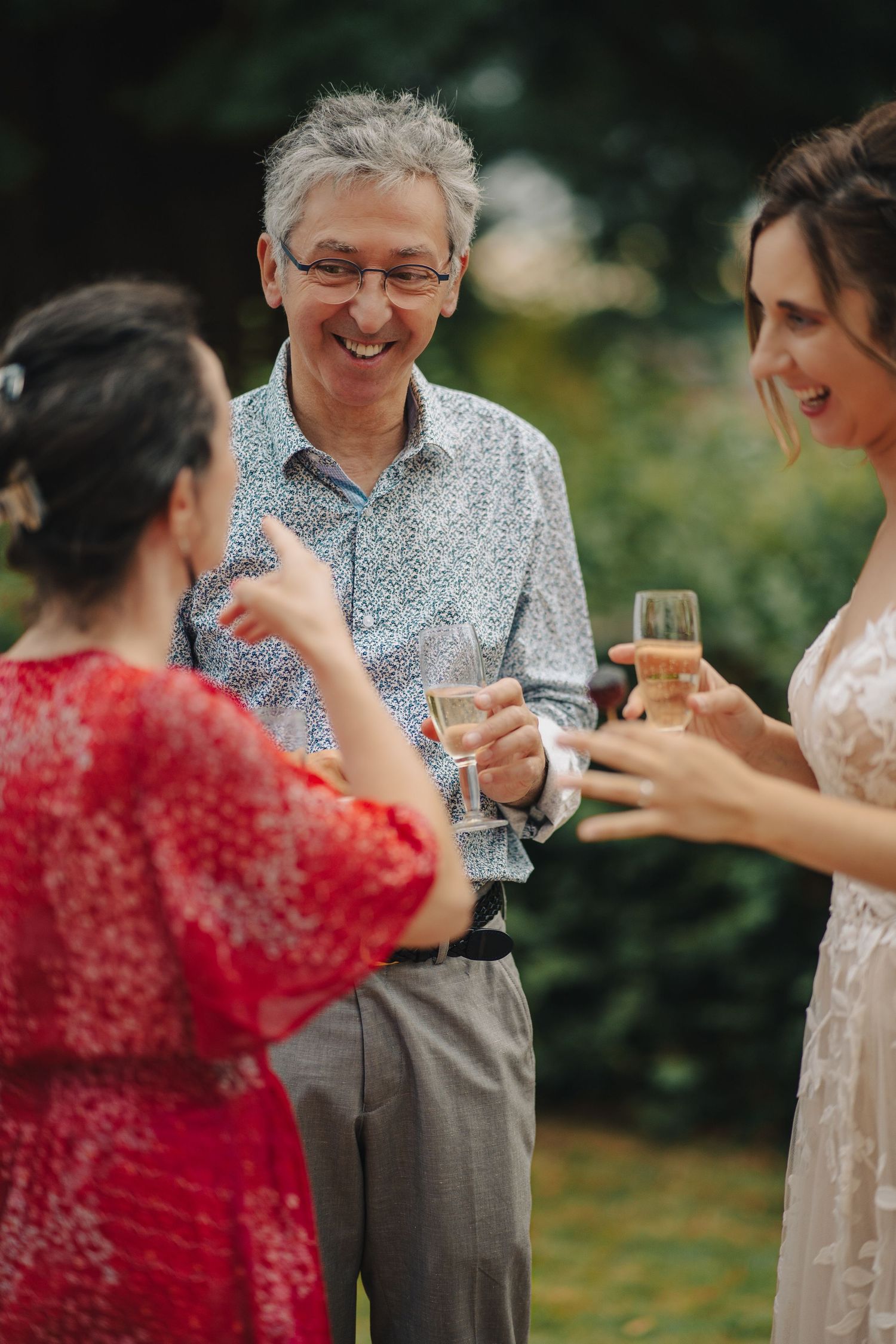 Guests enjoying drinks and conversation during an outdoor wedding reception.
