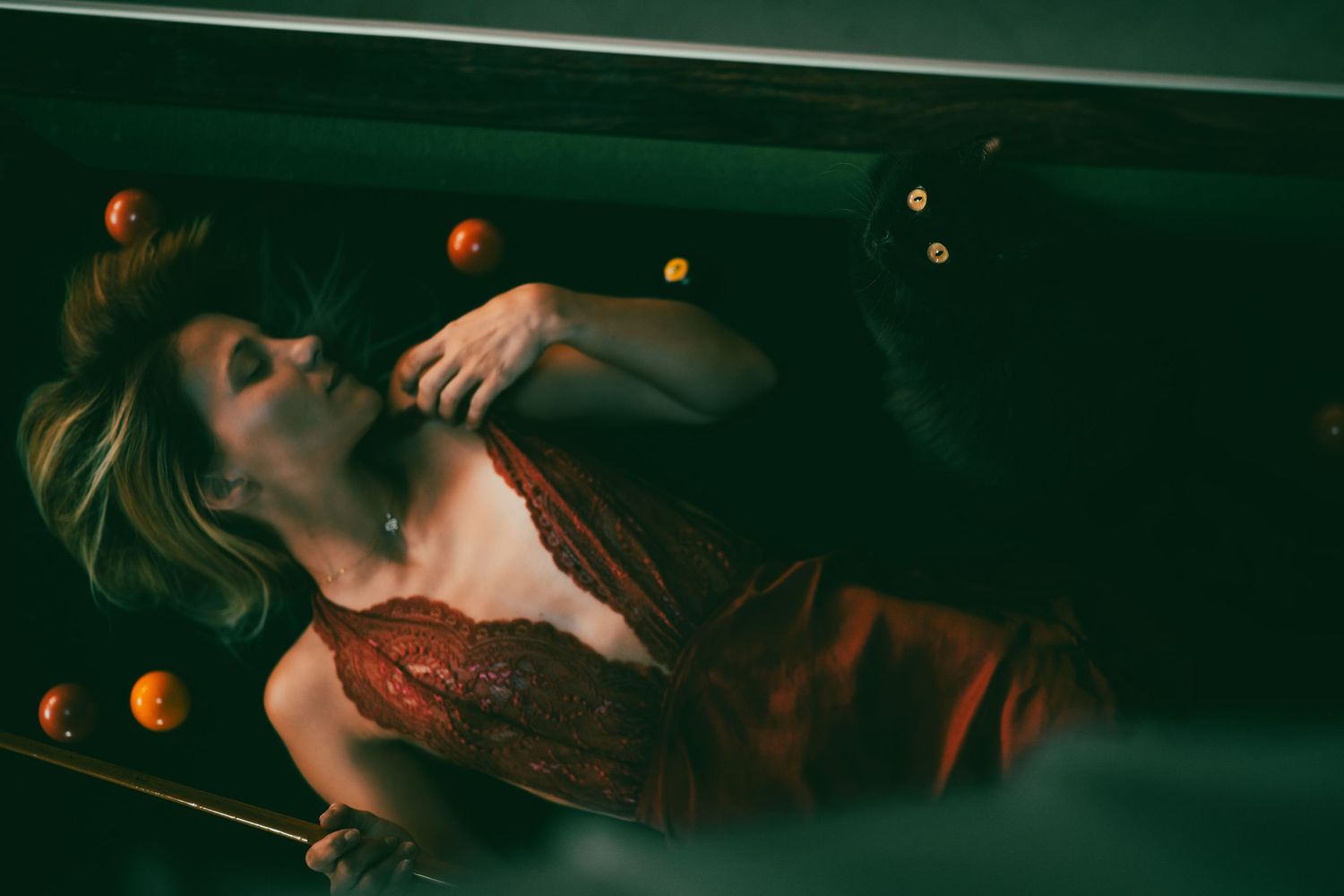 Dramatic low-light photography with warm orange accents in a dark setting.