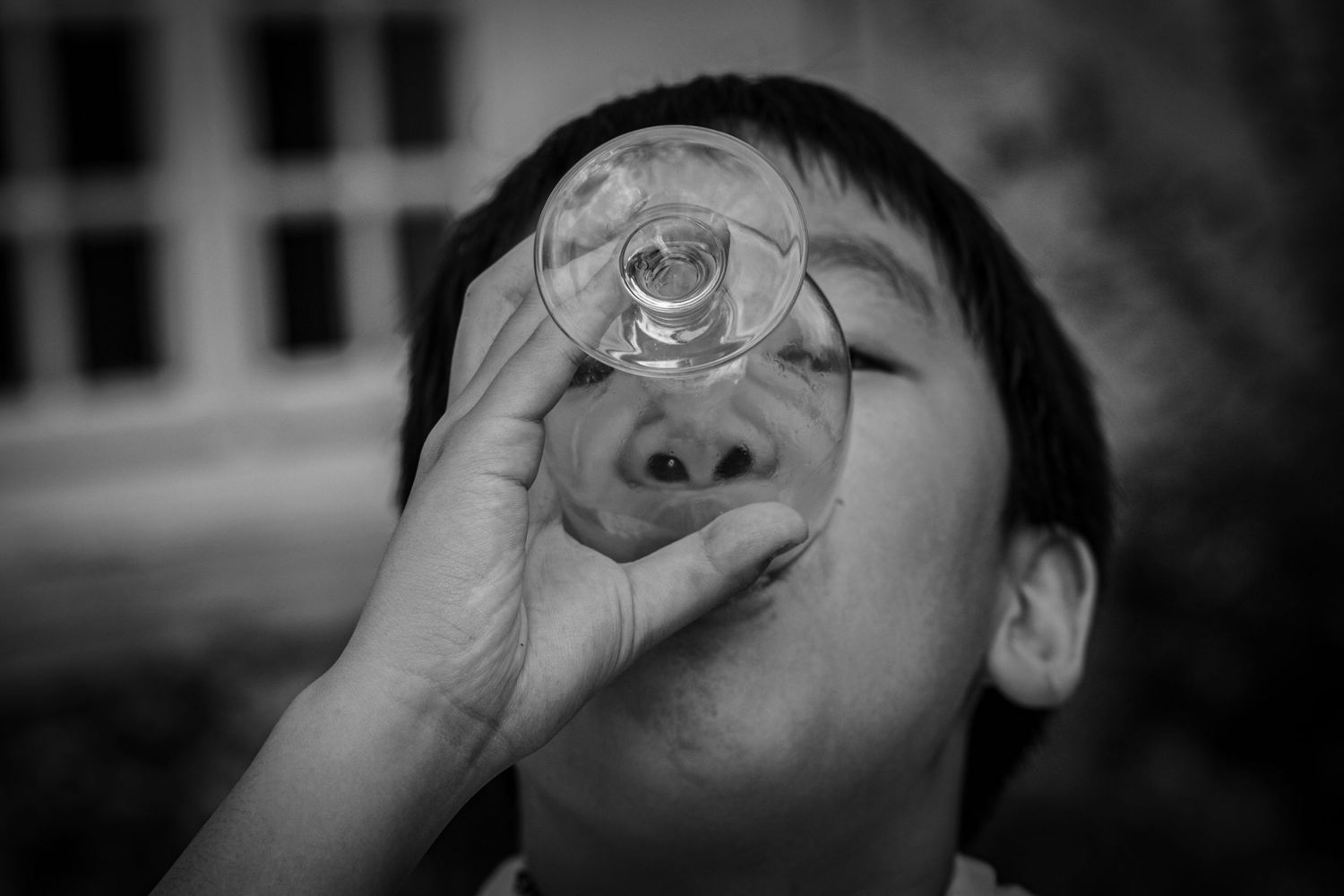 Black and white sequence showing someone drinking from a glass in dramatic lighting.