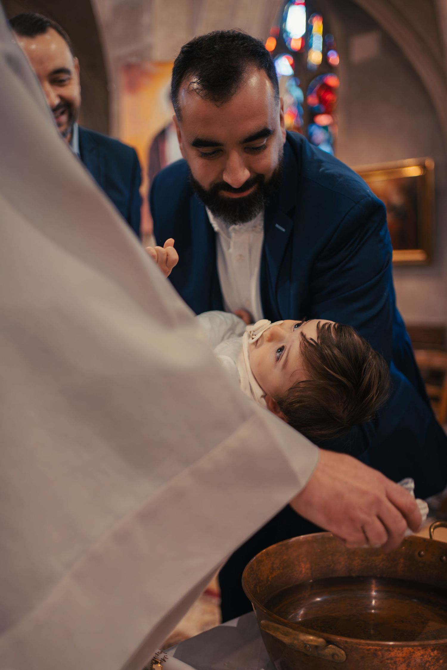 Sequence of baptism ceremony shots in warm indoor lighting.