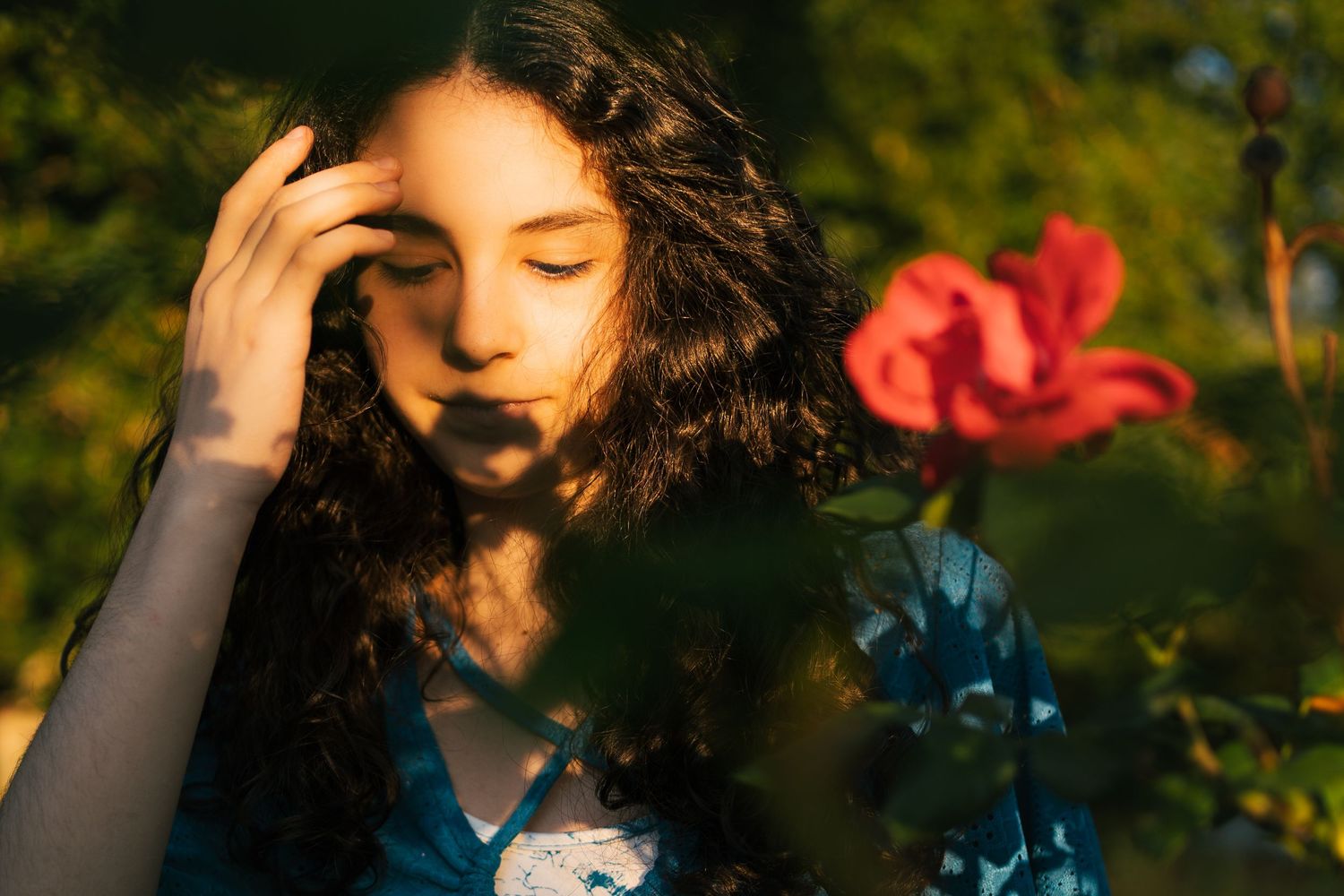 Moody outdoor portraits with natural sunlight filtering through trees.