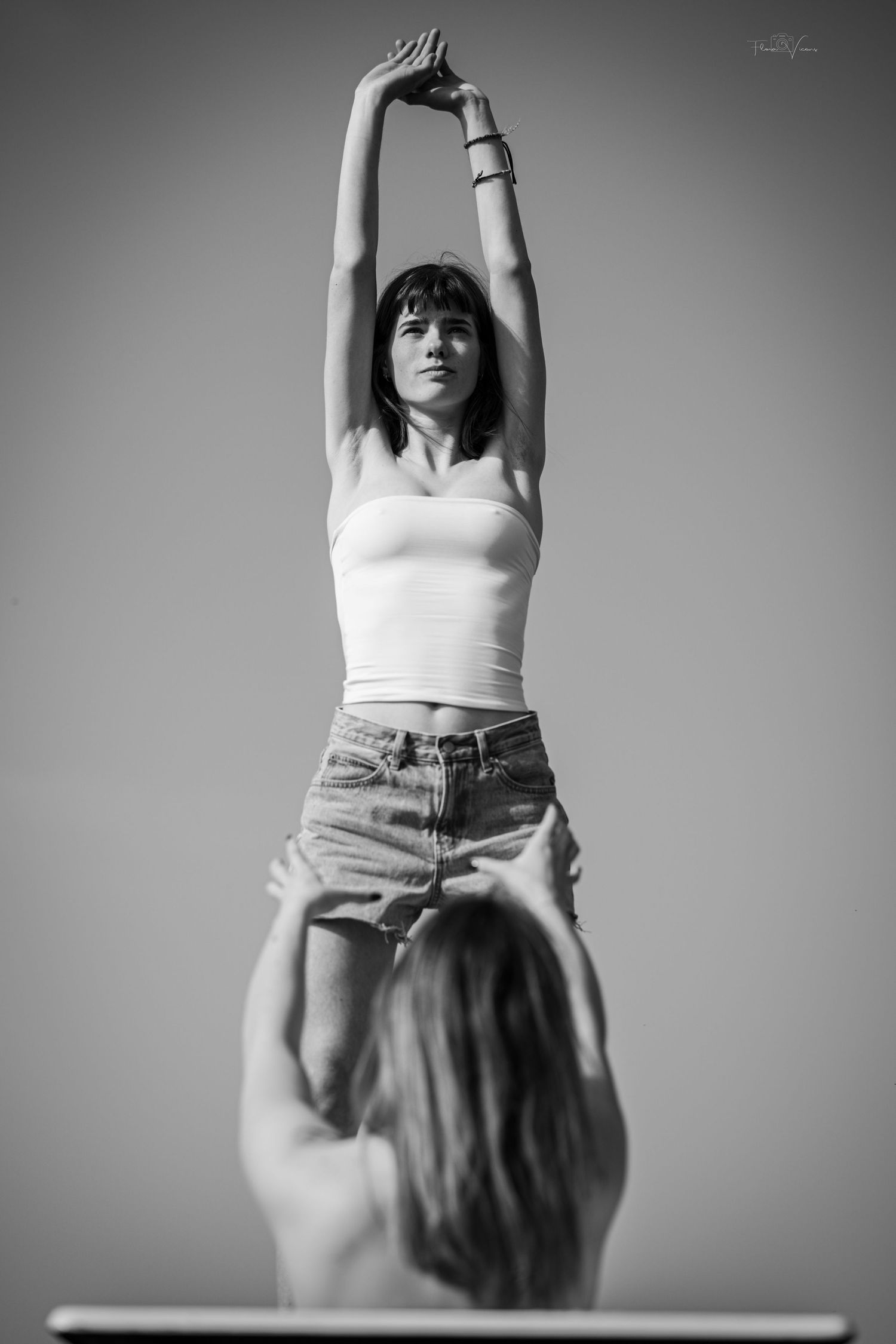 Black and white artistic portrait series showing graceful dance-like movements in a minimalist setting.