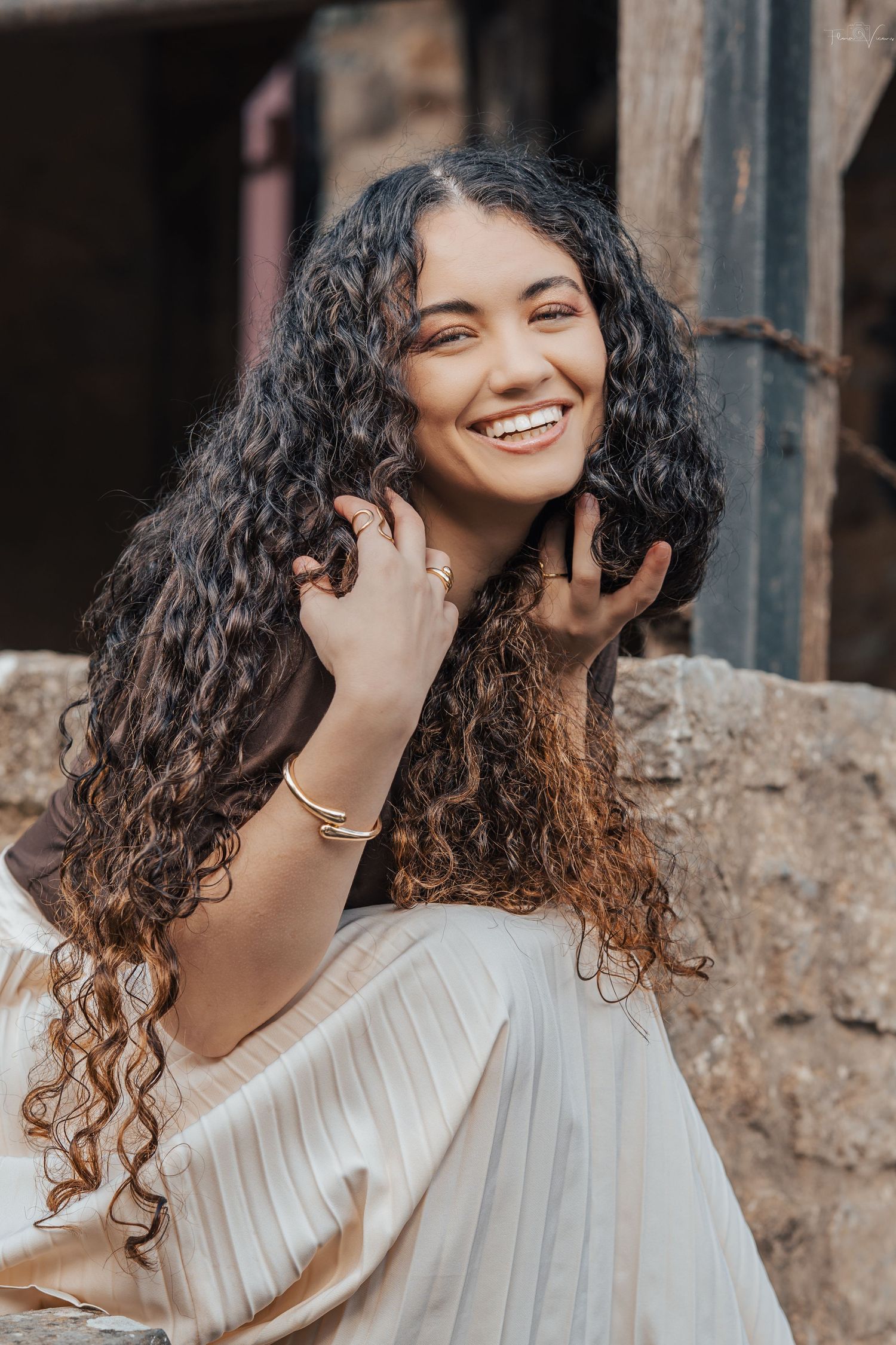 Portrait series showing joyful expressions against a rustic stone wall background.