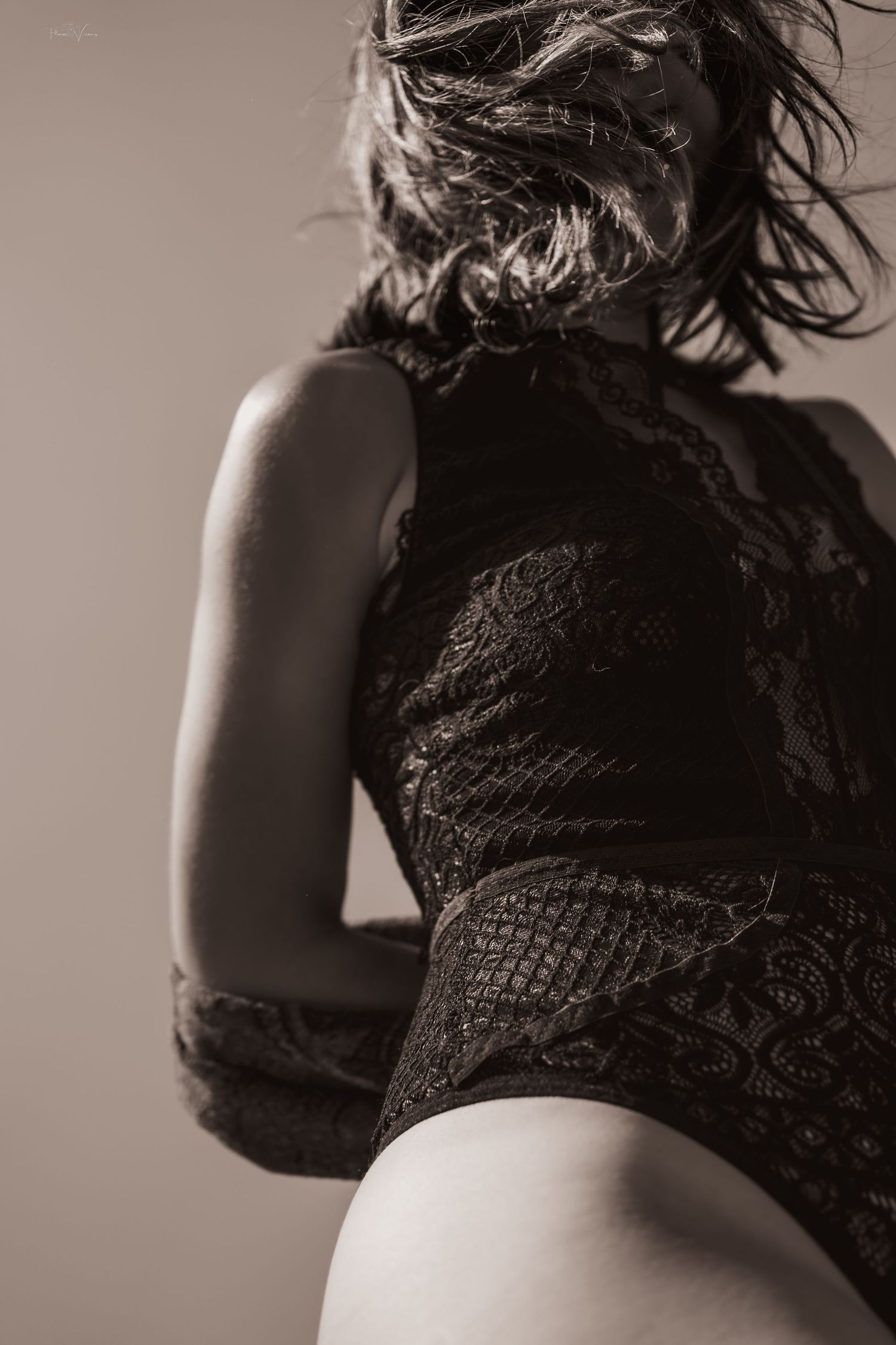 An artistic black and white portrait showcasing texture and movement in dramatic lighting.