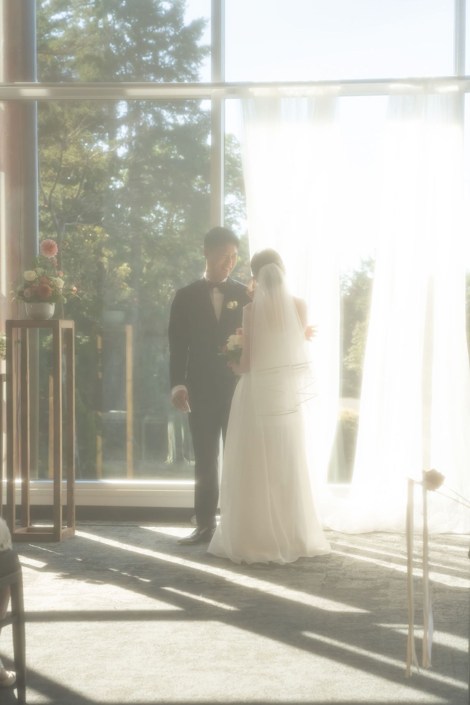 Bride and groom share an intimate moment at the altar, soft natural light streaming through large windows. Olympic Golf Club Victoria BC