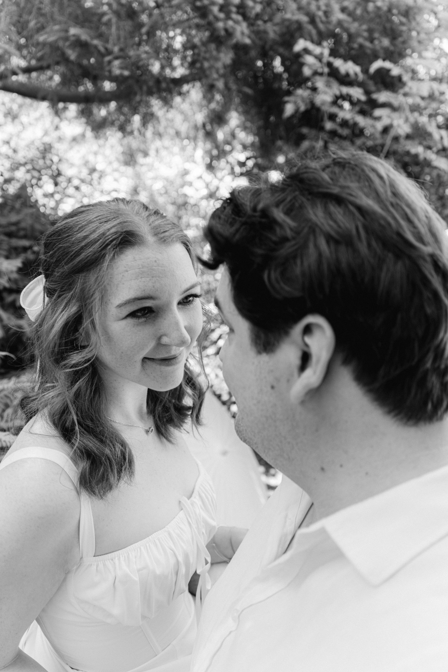 A romantic black and white sequence shows two people sharing intimate close-up moments outdoors.
