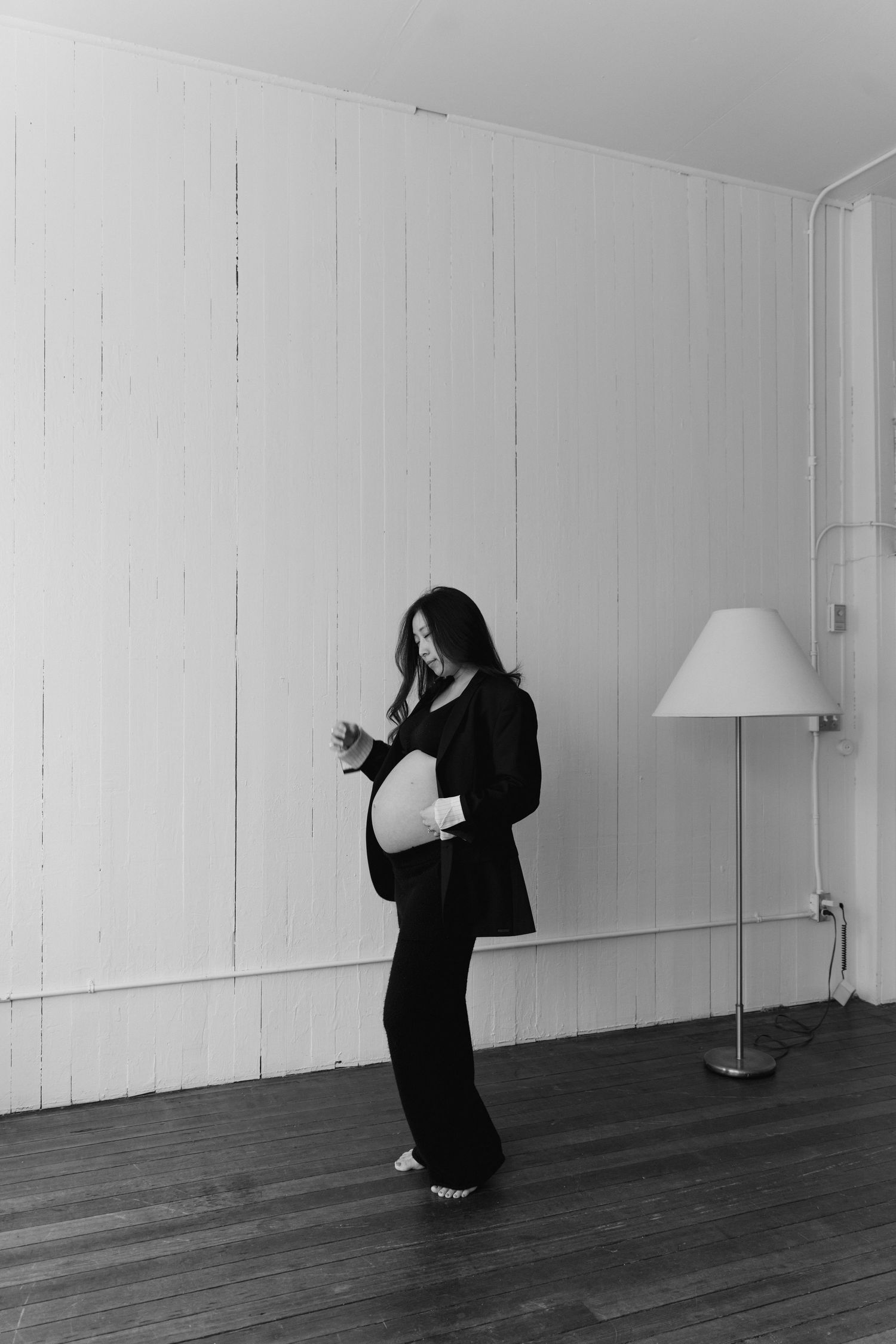 Dramatic black and white sequence showing figure in flowing movement against minimalist space.