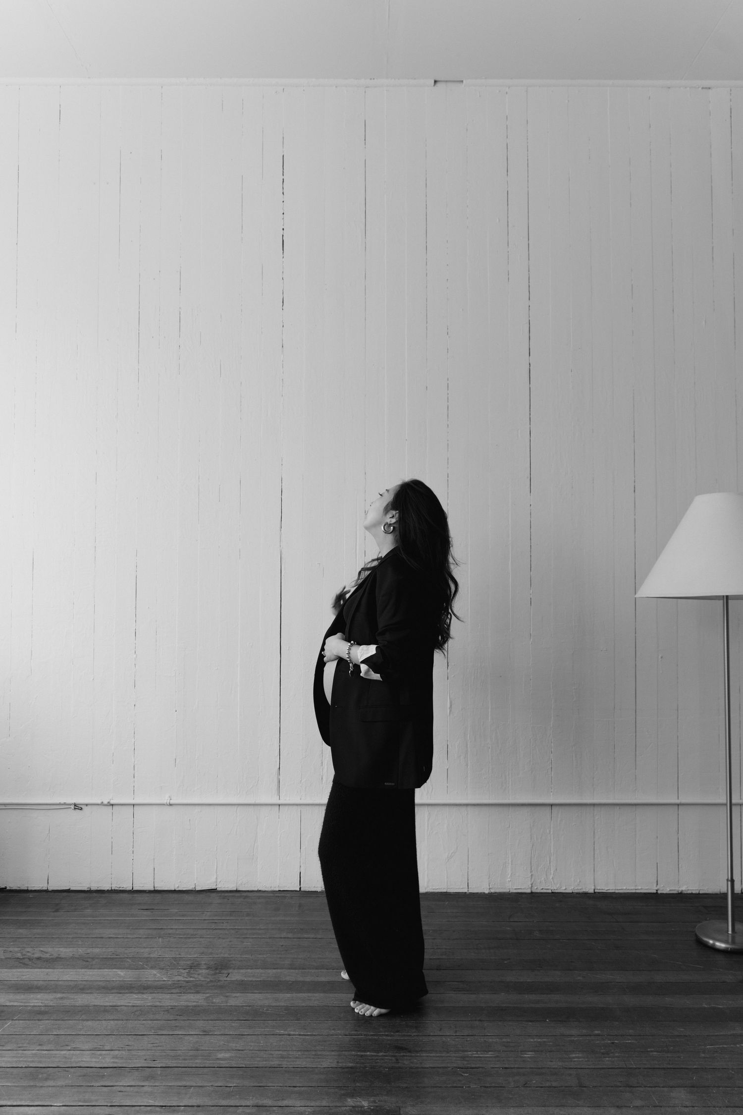 Artistic black and white photo series showing silhouetted figure in flowing dress against white wall at Rook and Rose loft Studio