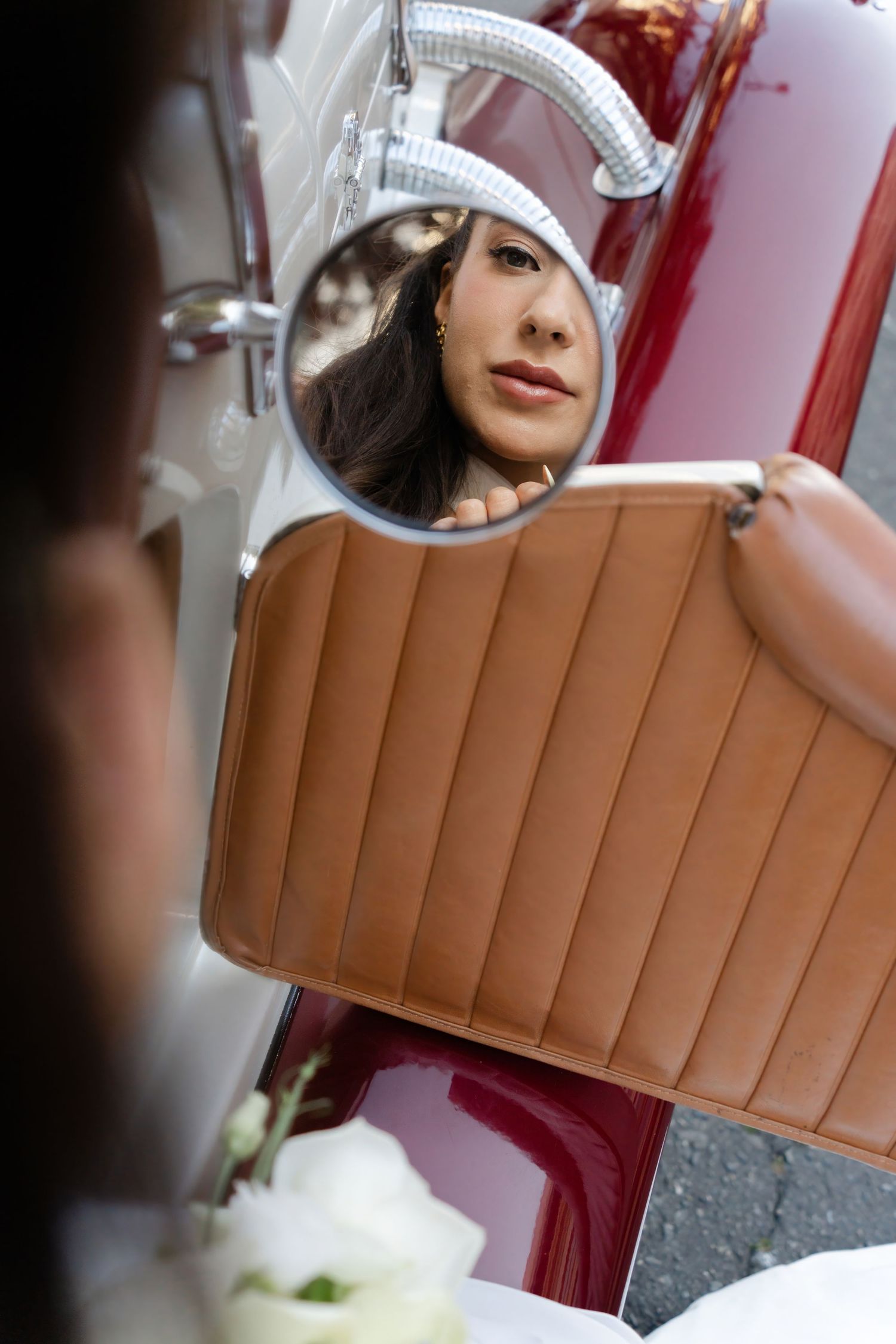 A series of mirrored selfie reflections showing someone in a white beanie hat and brown leather upholstery in the background.
