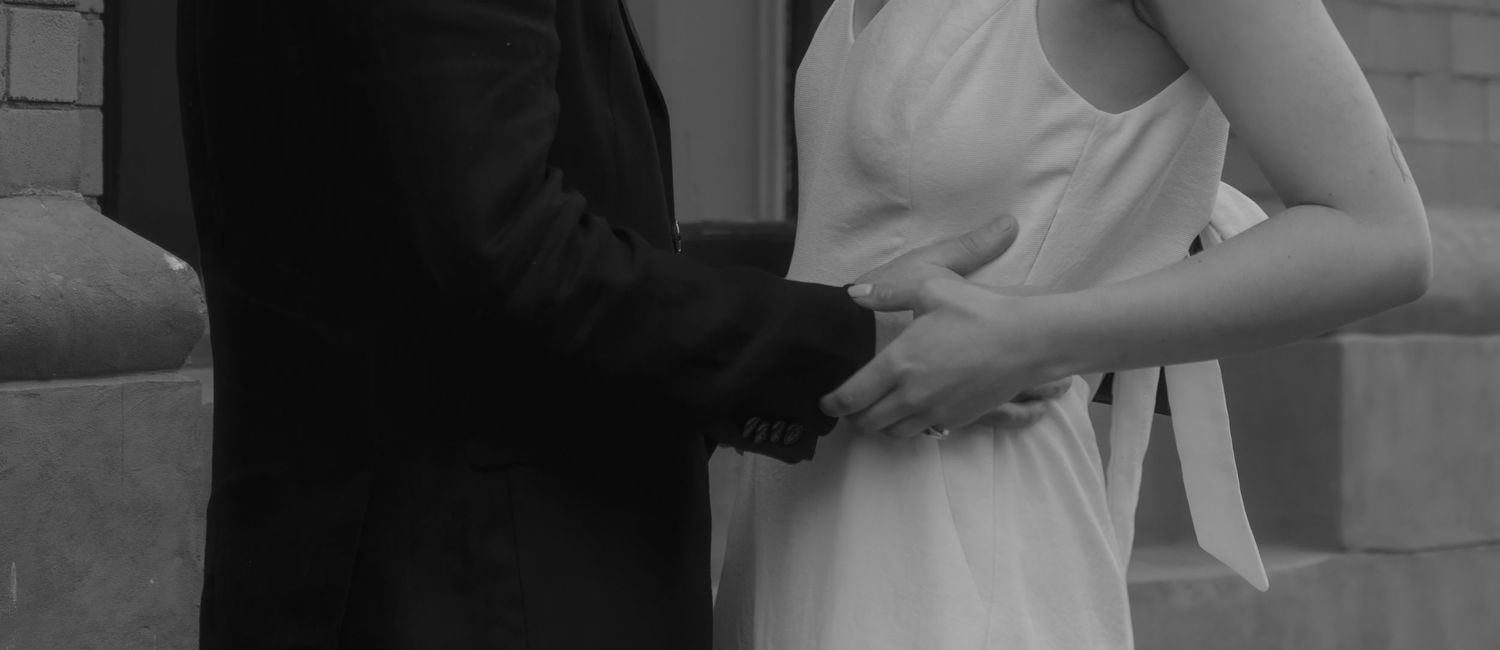 Black and white panoramic image showing silhouettes against a light background.