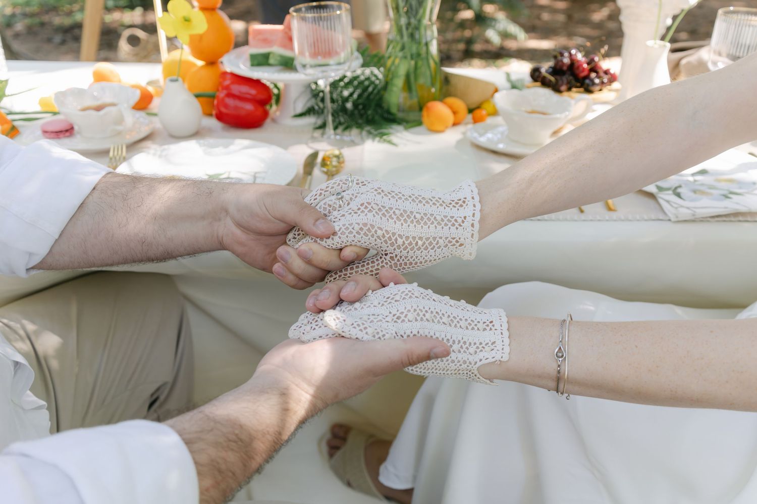 Close-up shots of hands exchanging items during wedding ceremony.