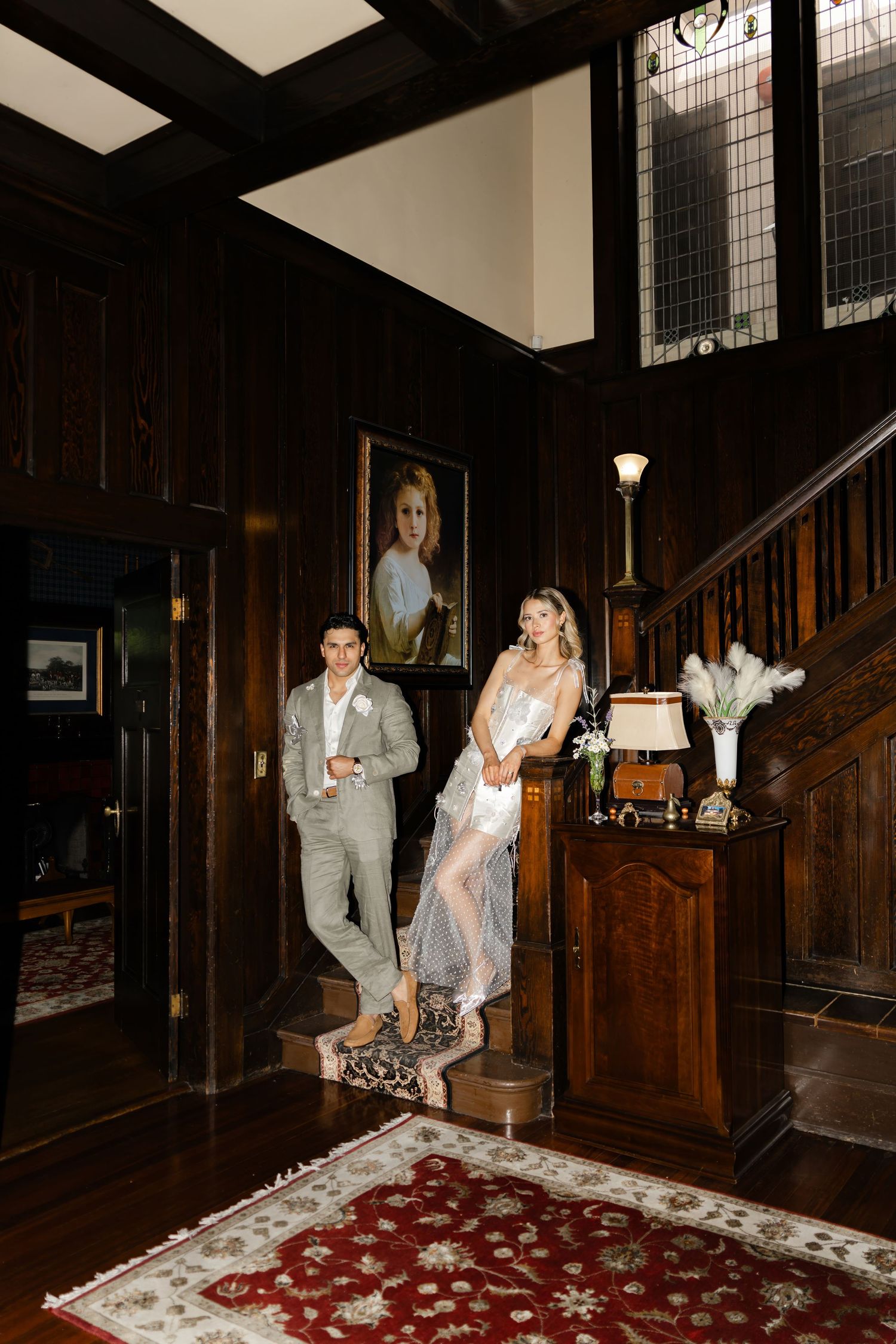 Nighttime scene in a wood-paneled room with figures on a patterned carpet.