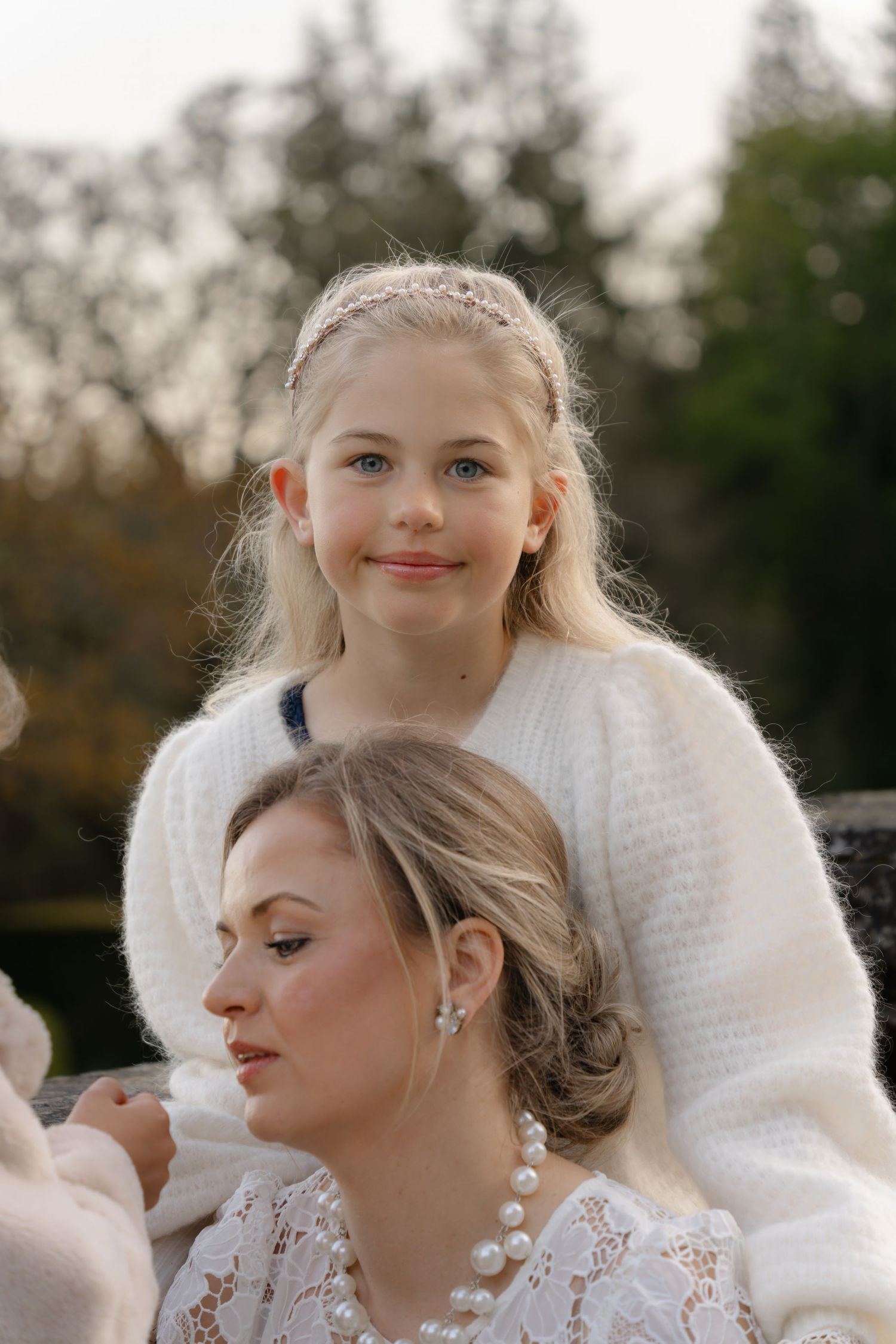 An intimate outdoor portrait capturing a tender moment against a natural background.
